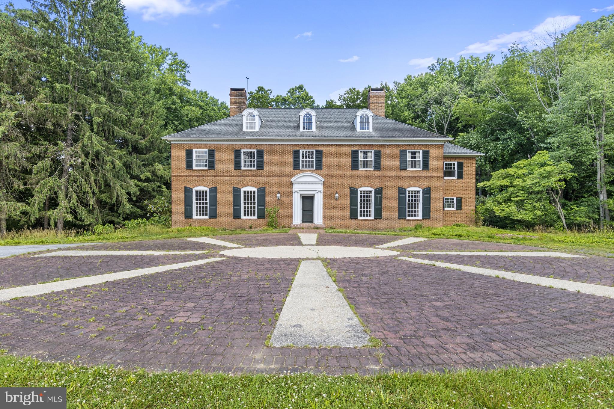 This classic Brandywine Valley estate sits tucked off of Hickory Hill Road in Pennsbury Twp on a picturesque 23-acre lot with rolling hills and partial wooded areas. This private location is immersed in nature and offers a blank slate for a future retreat from the large nearby hubs. A long driveway wends through verdant pastures past the original spring house to the breathtaking brick colonial home. A stately brick courtyard entrance welcomes you. Much of the home has been gutted to create a perfect canvas for a future dream home. Many of the original details remain including the grand 2-story turned staircase, soaring 10' ceilings, 5 classic fireplaces, timeless hardware and millwork and original wood floors on the second floor. Immediately begin to envision your future home as you pass through large rooms including the living room, dining room, library/family room and primary suite. The footprint currently offers the option for 5BR and 3.2 baths. A second turned staircase leads to the massive unfinished 3rd floor. Additionally the unfinished lower level walk-out provides more square footage with concrete floor and high ceilings. A sweeping brick patio sits off the rear of the house and overlooks a stunning and serene view of the wooded area surrounding the yard. The grounds are a nature lover’s paradise and include a 2-story bank barn, currently concrete flooring and can easily be converted to stalls for horses, equipment or any number of options. This home is located in the Unionville-Chadds Ford school district and is just minutes from downtown Wilmington Amtrak Station, Chadds Ford and Philadelphia airport.