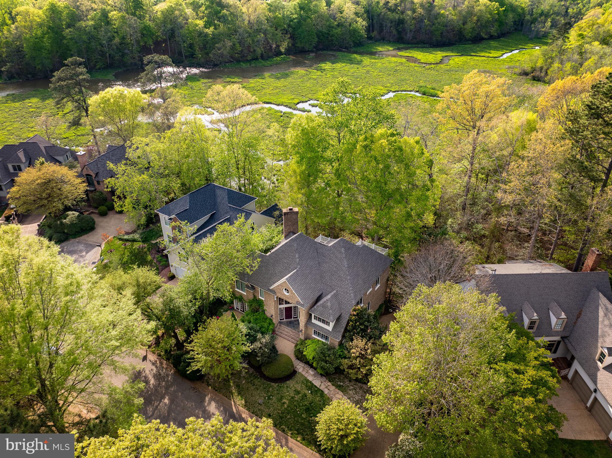 A phenomenal first offering in the coveted Port Anne: A custom, all-brick waterfront residence overlooking College Creek with sweeping creek views and timeless Williamsburg charm situated in an Audubon Habitat Sanctuary. With Architecture by Roger Guernsey himself with interiors by Gary Dennis Fine and built by Rob Collins, this approx. 3,000 sq. ft. home showcases vaulted ceilings, graceful archways, rich trim work, and a fantastic entertaining floor plan with true first-level living. The main level features a large primary suite opening to the screened porch, an office with private terrace, and a graceful kitchen with gorgeous glass cabinet details. Upstairs, three bedrooms each enjoy stunning views. A gardener’s delight with potting shed off the garage. Adjacent to Colonial Williamsburg, downtown dining, shopping, and College Landing Park. Elevator chute ready to connect all three levels. New roof (2025), newer HVAC(2023), and new hot water heater (2024) complete this rare offering.