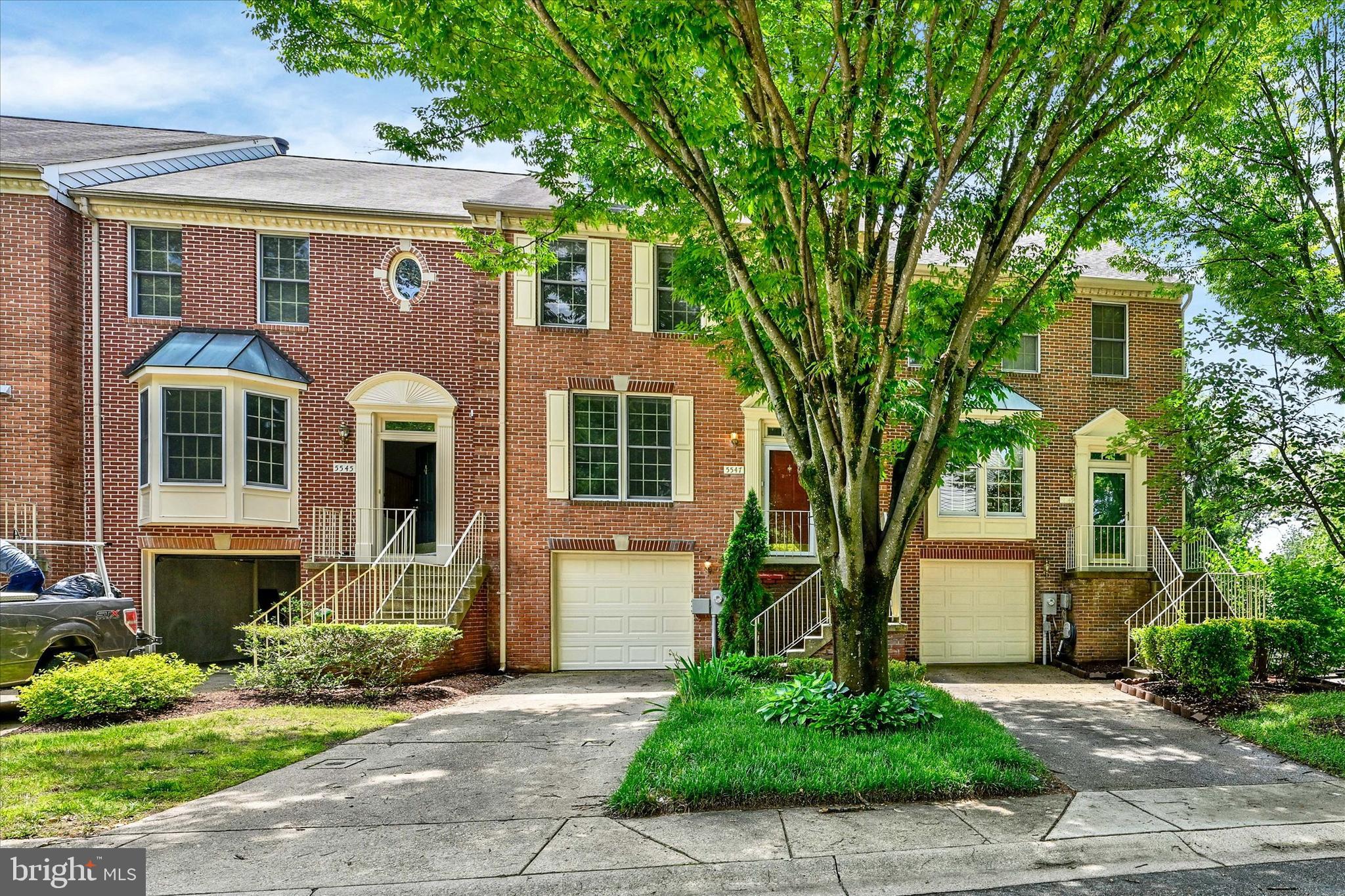 Welcome to 5547 April Journey, a beautifully updated brick-front townhome condo in the desirable Greens at Fairway Hills community of Columbia. Perfectly positioned backing to mature woods, this home offers exceptional privacy, peaceful views, and a serene natural backdrop rarely found in such a convenient location. With three fully finished above-grade levels, an open and inviting layout, and stylish updates throughout, this home blends comfort, elegance, and everyday functionality.

A welcoming foyer with updated statement lighting and rich hardwood flooring sets the tone from the moment you enter. The spacious living room is filled with natural light and overlooks the foyer and cascading staircase, creating an impressive sense of openness and architectural charm. Newer hardwood flooring continues throughout the home, with the exception of the stairs, providing a cohesive and polished feel across all three levels. Updated paint, newer lighting fixtures, crown molding, and thoughtfully selected finishes add a refined touch throughout the interior.

The home offers a wonderful flow for both daily living and entertaining, featuring a gracious living room, separate dining room, and beautifully updated eat-in kitchen. The gourmet kitchen is a true showpiece with premium stainless steel appliances, granite countertops, updated cabinetry, stylish hardware, a beautiful backsplash, generous prep space, and an inviting eat-in area. French doors open from the kitchen to a large wood deck overlooking the rear yard and mature trees, offering the perfect setting for outdoor dining, morning coffee, or quiet evenings surrounded by nature.

The family room provides an additional spacious and inviting living area, enhanced by rich hardwood flooring, recessed lighting, and a charming wood-burning fireplace with a classic brick surround and mantel. This flexible space is ideal for relaxing, movie nights, entertaining guests, or creating a comfortable home office or recreation area. French doors lead directly from the family room to the private brick paver patio, extending the living space outdoors.

Tucked beneath the expansive deck, the patio offers a covered outdoor retreat with a peaceful view of the pristine backyard and wooded setting. Whether used for shaded seating, grilling, quiet relaxation, or entertaining, this private patio creates a wonderful connection between the interior living spaces and the natural surroundings. The rear yard and mature trees provide a sense of privacy and tranquility, making the outdoor spaces feel like a true extension of the home.

The recently updated baths offer a fresh, modern feel with tasteful finishes, further enhancing the home’s move-in-ready appeal. A private one-car garage bay provides secure parking and storage, while the concrete driveway offers additional off-street parking for added convenience.

Enjoy the best of Columbia living with fantastic shopping, restaurants, recreational parks, and trails just minutes away. Conveniently located near major routes including 100, I-695, I-95, Routes 1, 32, and 216, the home offers easy access to Baltimore, Washington D.C., and Annapolis. A short commute to NSA, Ft. Meade, Johns Hopkins APL, and MARC train stations makes this an ideal location for commuters. Served by Howard County public schools, this Greens at Fairway Hills townhome condo truly checks every box.