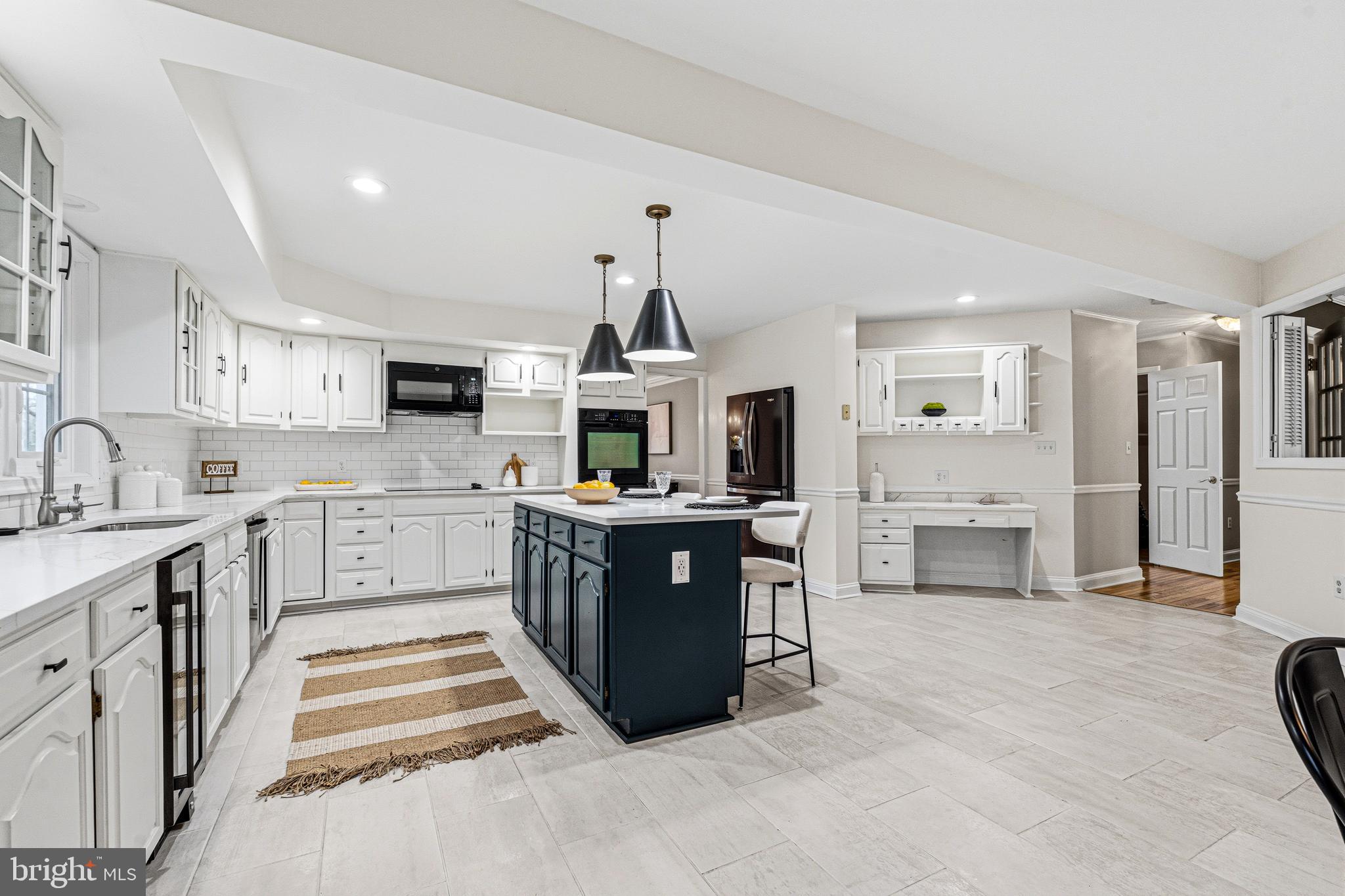 Beautifully maintained and thoughtfully updated 5-bedroom, 3.5-bath residence set on over an acre in the Advocate Hill Farms community. Offering more than 5,500 square feet above grade and over 8,000 total square feet, this home combines scale, craftsmanship, and refined updates throughout.

The main level showcases newly refinished wood flooring, soaring ceilings, and an expansive, well-designed layout. Multiple living and entertaining spaces include formal and casual areas, each enhanced by detailed millwork, abundant natural light, and five fireplaces that create warmth and architectural interest.

The kitchen is designed for both function and style, featuring a large center island, table space, generous cabinetry, and seamless flow into surrounding gathering areas. French doors and large windows frame views of the property and provide access to outdoor living spaces, including a wraparound porch and rear deck.

Upstairs, the primary suite offers a spacious retreat with a fireplace, private bath, and ample closet space. Additional bedrooms are generously sized and supported by well-appointed baths.

The full lower level with outside access provides substantial space for storage, recreation, or future customization.

Additional highlights include a 3-car attached garage, geothermal heating and cooling, central vacuum system, and private well with septic. The property is set on approximately 1.07 acres with mature landscaping and a tree-lined backdrop, offering a peaceful and expansive setting.