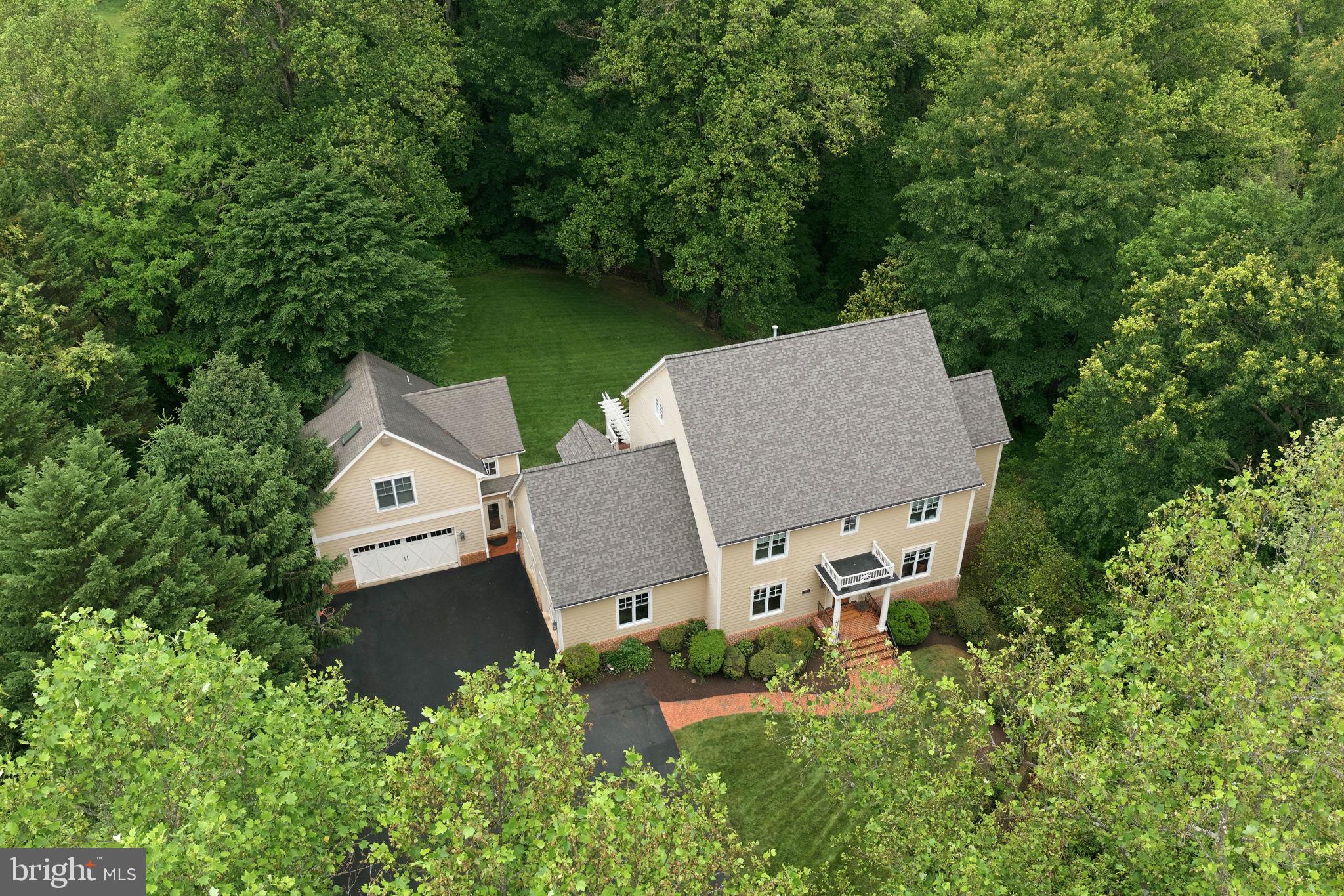 A rare opportunity to enjoy the privacy of a four-acre estate while remaining close to town, shopping, and major commuter routes!  Set far back from Hunter Mill Road, this exceptional property combines serene surroundings with unmatched accessibility — truly the best of both worlds.   The additional  detached garage with finished living space could be used as a guest house or on site office.  Beautifully updated throughout, the main level features a stunning new kitchen, formal living and dining rooms, family room leading to a large covered porch and deck, private study with built ins, and a mud room.  Upstairs is a wonderful primary suite with show stopping bathroom and amazing closets.  There are three additional bedrooms, two updated full bathrooms and a new laundry room.  A bonus loft level features two additional rooms, currently being used as a playroom and craft room. This is ideal flex space for work, hobbies, fitness, or guests.  The walk-out lower level offers exceptional recreation space including a game room, wet bar, theater room, bedroom, and full bath. Step outside to a gorgeous patio complete with hot tub for year-round enjoyment.  A built-in sound system enhances the home's entertaining appeal.  Updates include a new roof, all new wood flooring, carpeting, painting, lighting fixtures and new asphalt driveway.  A standout feature of the property is the oversized detached two-car garage with approximately 600 square feet of finished living space above, complete with a kitchenette and half bath that could easily be converted to a full bath. Perfect for an office, studio, or guest suite. With four oversized garage spaces, extensive driveway parking, wooded privacy, and a location less than five minutes to I-66, the Dulles Toll Road, grocery stores, and town amenities, this property delivers an extraordinary lifestyle rarely found in today’s market.