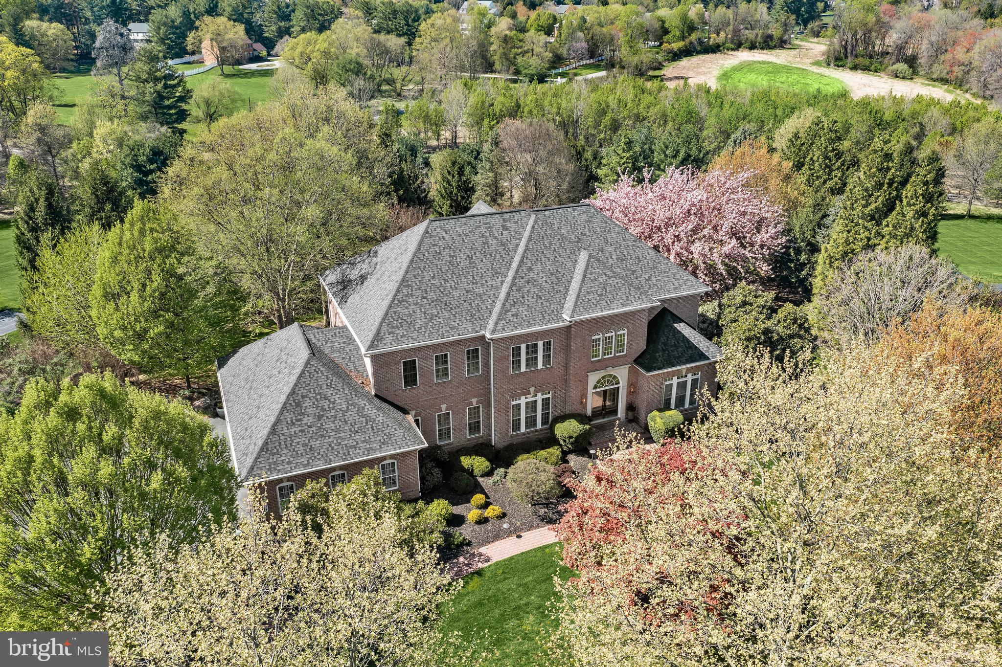 Introducing this exquisite home tucked away in the sought-after Belmont Farm neighborhood, featuring five bedrooms accompanied by five full bathrooms and two half baths. NEW HVAC, NEW PREMIER SS APPLIACES, NEW ROOF (2020) and NEW WATER HEATER!! Spanning three levels, this exceptional home offers unparalleled living spaces, both indoors and outdoors, set on a beautifully landscaped 1.43 acre lot. Showcasing ornate trim moldings, wainscotting, coffered and tray ceilings, sun-filled windows, 10-foot ceilings, a freshly-painted neutral color theme and updates throughout. Step inside where the two-story foyer greets you with a dramatic curved staircase leading upstairs. Off the foyer, the elegant dining room is perfect for hosting dinner parties. Kick your feet up and relax in the family room, complemented by a cozy gas fireplace with stone surround. Prepare your favorite meals in the gourmet chef’s kitchen, fully equipped with two islands, a walk-in pantry, granite countertops, tile backsplash, BRAND NEW premier stainless steel appliances, a planning desk, and a breakfast nook for casual meals. The main level also hosts an office that is ideal for working from home with privacy. Finishing the main level are two half bathrooms and a laundry room with built-in shelving. Ascend upstairs where the expansive primary suite awaits, complete with a sitting room and two large walk-in closets. The luxurious bathroom features a jetted soaking tub, a large walk-in shower, separate water closet, and a massive vanity with dual sinks. Down the hall, the second bedroom suite includes a private bathroom. Another two bedrooms with walk-in closets and private en-suite bathrooms complete the upper level, along with a cedar closet and additional storage. The fully-finished lower level is an entertainer’s delight with space for everyone’s activities. The game room features a full-size wet bar and a dual-sided gas fireplace shared with the recreation room. Additionally, there is a home theater with tiered seating, an exercise room, and tons of storage. The lower level also offers the fifth bedroom suite with a walk-in closet and private full bathroom. Discover the outdoor features designed for entertainment and relaxation, with a deck overlooking the rear yard that backs to trees. The paver stone patio boasts an outdoor tiki bar with a grill, television and fire pit. The oversized four-car garage has an electric vehicle charger and additional storage. There is also a whole-house generator, a lawn irrigation and sprinkler system. Recent improvements include a new roof in 2020, a new HVAC system and a new water heater.