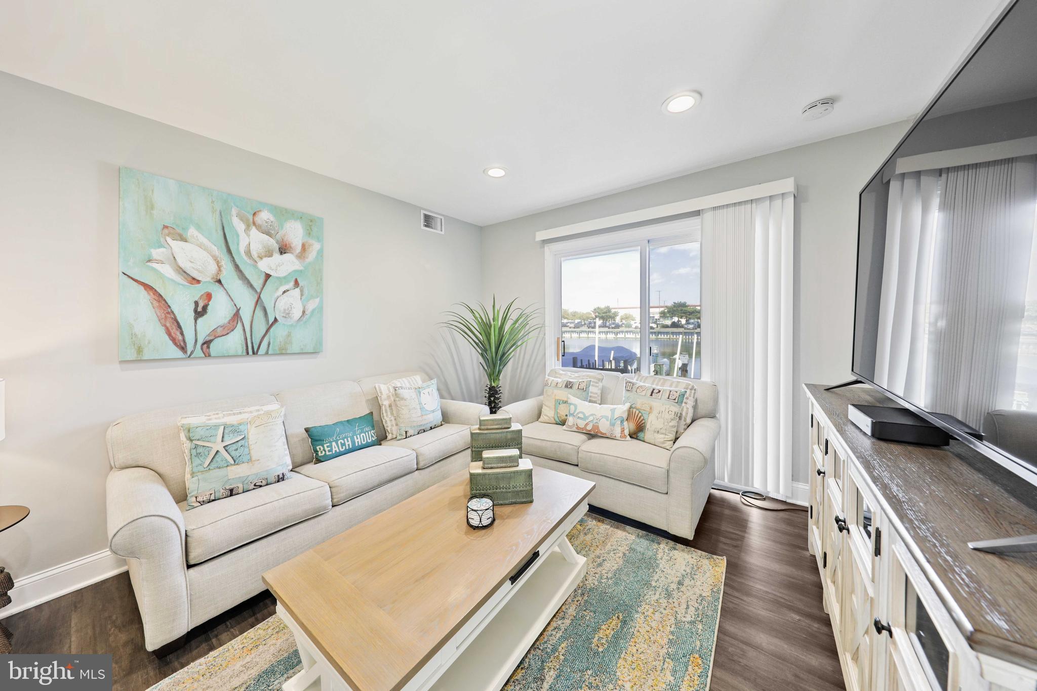This is 3 bedroom 2 bathroom townhome that was completely renovated within the past year. This home has a brand new HVAC system and Water Heater. Complete renovation is not an exaggeration, as the owner took the home down to the studs and completely redid everything from the walls, to the floors, to all bathrooms and the kitchen. The builder also created an owners suite bedroom with en-suite owners bathrooms. There is an outdoor deck that can be accessed from the owners suite as well as access from the living room. Sit and enjoy the water view of the  inlet from your home. This boat slip is deeded to the home and has a boat motor to pull up and drop your boat depending on the tide. The home is located right across the street from a public beach access, so it take less than 5 minutes to walk to the beach and dig your toes into the sand. There is a private pool that all members of this community  have access to. The condo is located right beside a the Green Turtle shopping center and there is even a walk way to the Food Lion grocery store that is only a 2 minute walk from the home. There is an options to include all of the brand new furniture into the sale. Please ask agent for furniture details.