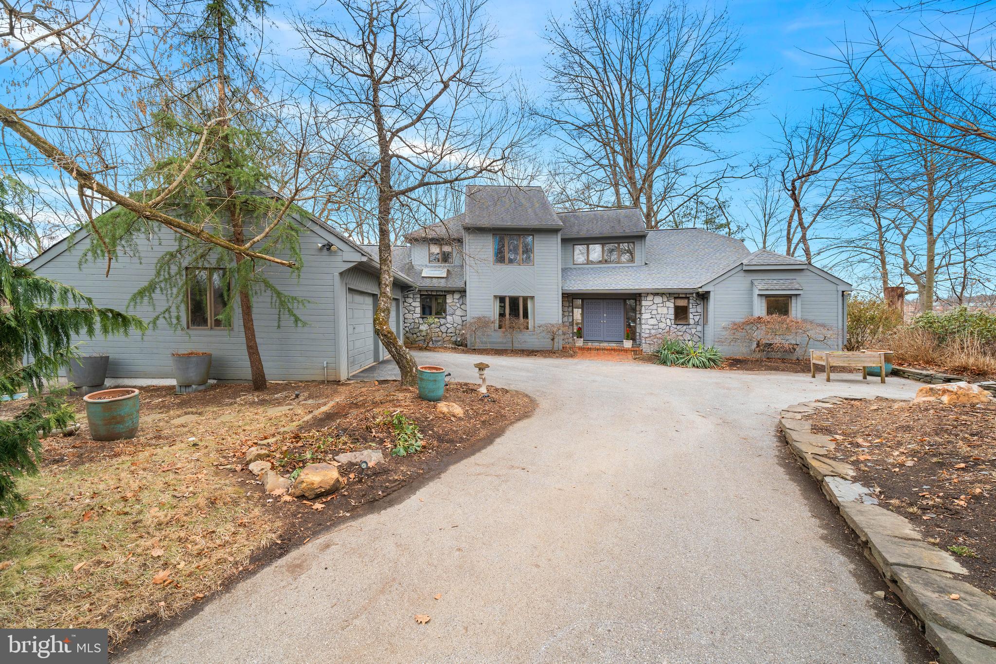 This custom stone and cedar home is unlike any other in the highly sought-after community of
Radley Run Country Club. Set on a cul-de-sac and backing onto the Brandywine River and a
small horse farm, this stunning property is unmatched in tranquility and privacy. It was the
builder’s personal home so features many unique touches.Each room is positioned to capture natural light and gorgeous views. Upon entering the home, you’ll find an impressive two-story foyer with polished onyx floors. The exquisite great room with a stunning stone fireplace and soaring ceilings brings the backyard sanctuary in through the floor-to-ceiling windows and two large skylights. The family room features a second
fireplace, floor-to-ceiling windows and new Anderson sliding doors. The white oak hardwood
floors have been beautifully refinished. The open-concept floor plan is perfect for entertaining and family fun. The house easily transforms from private sanctuary into the perfect home for entertaining as the great room,family room, dining room, kitchen and breakfast rooms all flow into each other and open onto aforty-foot custom deck constructed from Brazilian IPE and a large private yard with extraordinary views and privacy.The desirable first-floor primary suite includes a bedroom with sitting area, beautiful Porcelanosa floors with radiant heat and large windows. The terrazzo-tiled bathroom with its
skylight over a jetted soaking tub is perfect for relaxation after a hard day. There is also a
modern open shower. The cabinet doors have been inset with custom stained glass from a well-
known Chadds Ford artist. For your morning coffee or evening cocktails there is a personal
stone veranda off the suite with a brick pathway to a gazebo that overlooks the Brandywine
River.The large open kitchen with a skylight and high ceilings is a chef’s dream with granite
countertops, sparkling new appliances including a double wall convection oven and a sleek
ceramic cooktop with downdraft venting. Peninsula seating on the large island to the side of
the kitchen provides more open space for shared cooking and family time. In addition to the
peninsula seating, there is a dedicated dining room and a light-filled breakfast room. The
breakfast room has soaring ceilings and opens onto the large deck which is the perfect spot for
any meal. A double window overlooking fabulous landscaping makes even doing dishes a
delight. The large laundry room is distinctive with slate floors and a custom pantry. The office is
located off the great room and provides privacy while still feeling like it’s part of the home.
Upstairs you’ll find three newly carpeted oversized bedrooms with a walk-in closet, a large
bathroom, a cedar closet and incredible views of frolicking horses and the Brandywine River.
The full basement has high ceilings and new windows. It could easily be finished to add a spa, a
play room and an entertainment center increasing the size of the house by several thousand
square feet. There is a new Trane heating system. This house also has an oversized two car
garage with additional shop space.The meticulously landscaped grounds feature plum trees, Japanese red maples, peach trees,weeping cherry trees, ferns, hellebores, rhododendrons, crepe myrtles, weeping larches,
hydrangeas, nepeta, Brunnera, lilies, amsonia, hosta and lambs ear. Every spring the property
explodes with color.Additionally, there are new Anderson sliding doors, fresh paint throughout, a custom fence surrounding the property constructed from cypress and hemlock that will last decades, an IPE
deck that is so durable if the house burned, it would survive, a fifty-year roof with 6” gutters, an
upgraded electrical panel, an EV charger in the garage, motion sensor lights surrounding the
house and much more. This home is located in the award-winning Chadds Ford Unionville school district. Radley Run Country Club offers golf, swimming, tennis and dining perfect for all ages!