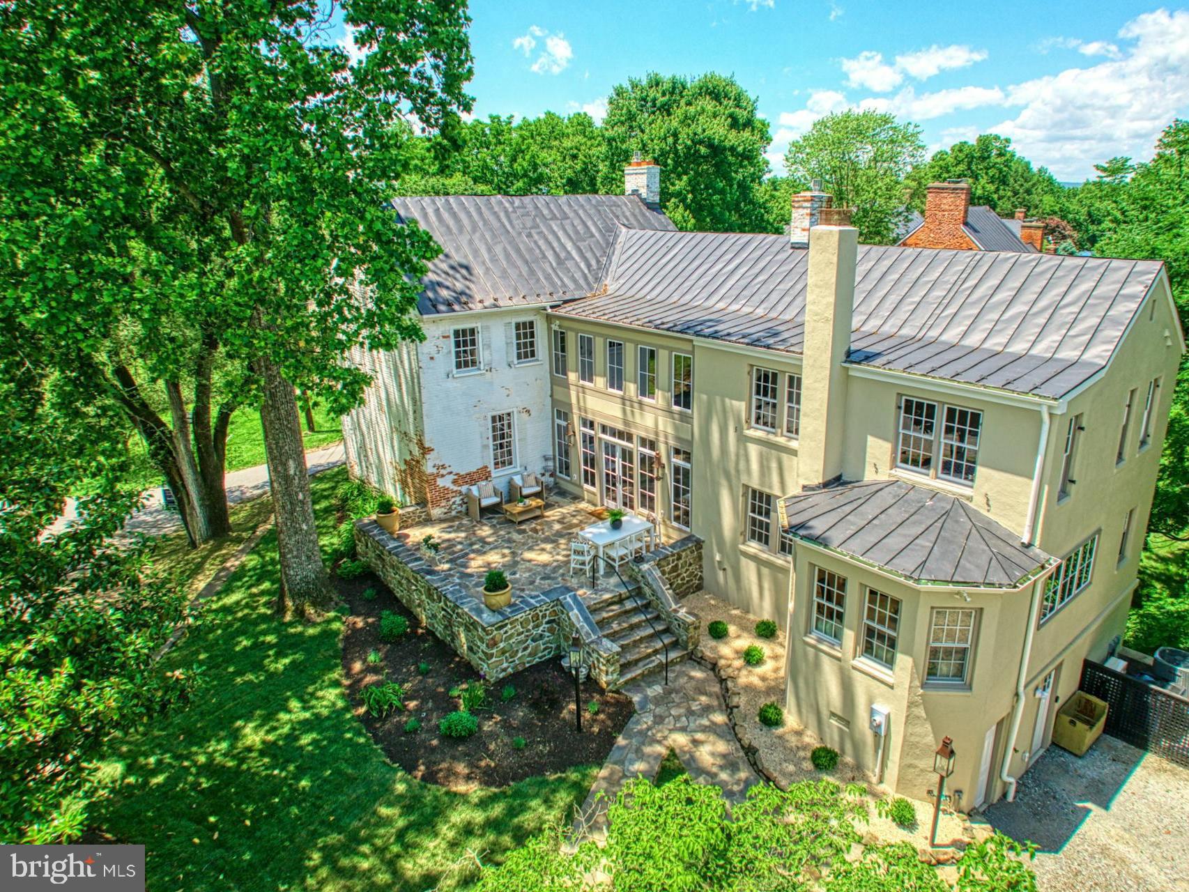 This remarkable home seamlessly blends historic elegance with contemporary comforts. From the meticulously designed kitchen to the luxurious butler's pantry and inviting living room, every detail has been thoughtfully curated.
Featuring 4 bedrooms and four and a half baths, this home also boasts a flagstone patio, 3 working fireplaces, and beautifully landscaped grounds with a gated garden. The HVAC, electrical, and plumbing systems have all been updated, ensuring modern reliability.
Located in the heart of Waterford, you'll enjoy the tranquil village atmosphere while being just a short drive from modern conveniences. This home is a rare gem, offering both timeless beauty and modern luxury. Don't miss the opportunity to make it yours!

Built in 1801, the house has a rich history. Mahlon Janney (1731-1812), son of Waterford’s founder Amos Janney, commissioned Edward Dorsey to construct this residence on “the Big Hill” of Main Street. Originally facing Main Street, the house was Janney's home until his death. In 1818, Charles G. Edwards, a physician trained at the University of Pennsylvania, purchased the property from Janney’s widow, Sarah. Dr. Edwards lived here until his death in 1851.

By 1894, the house was the residence of Ann Elizabeth Bond Hough, widow of Amasa Hough Sr. African American teacher William B. Minor later bought it for about $500. At Minor’s death, the recently-formed Waterford Foundation acquired the house, known as the “Dr. Edwards House,” to stabilize and preserve it. Subsequent owners made significant modifications, including removing interior partitions on the first floor to create one uninterrupted space, adding an Italianate touch with window treatments in a new wing, relocating the front door to open onto a patio, and painting the brick white.
Located in the heart of Waterford, this home offers the tranquility of village life with the convenience of being a short drive from modern amenities.
This home is a rare gem, offering both timeless beauty and modern luxury. Don’t miss the opportunity to make it yours! Contact us today to schedule a viewing and experience the charm and sophistication of this exceptional property.