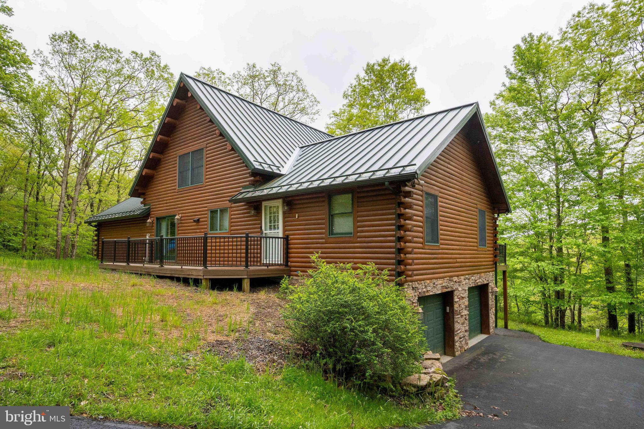 One-of-a-kind Youghiogheny riverfront estate offering  400 feet of water frontage on 5+ acres and 2 separate lots. Soak in the sounds of the flowing waters and chirping birds, cloaked in a private canopy of mountain laurel, pine trees and mature hardwoods. 5BR 4.5 BA log masterpiece with attached 2 car garage and paved driveway. Thoughtful design and well maintained with spacious suites, floor to ceiling fireplace, log accent walls and exposed beams. Features include multiple fireplaces (wood & gas), Andersen doors & windows, trex decking, hardwood floors, metal roof, custom cabinets in kitchen & bedroom suites, eat-in kitchen, and sold furnished! Enjoy a picturesque setting in a riverfront setting with NO HOA restraints for this home.