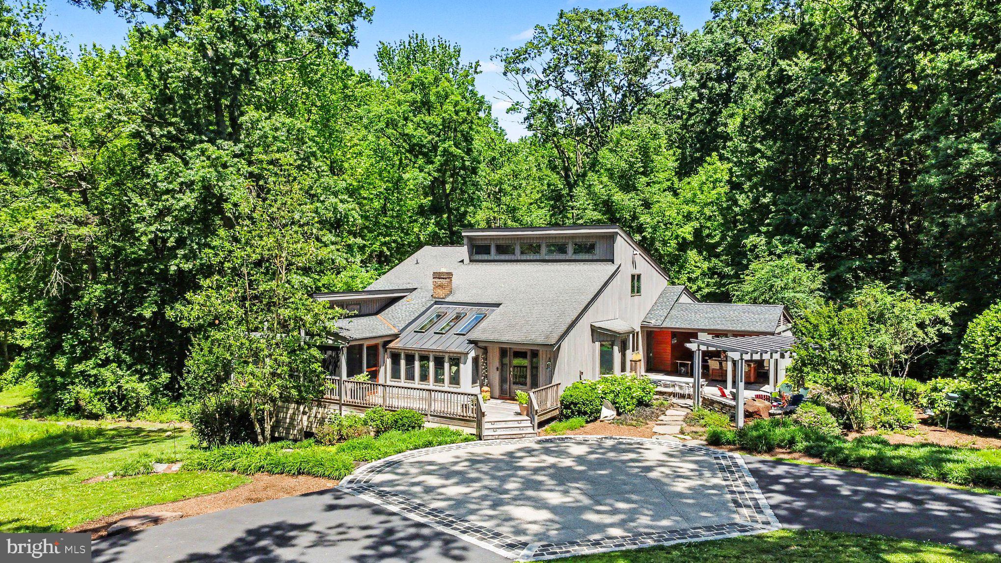 What a rare find in beautiful Havre de Grace. You will appreciate the distinguished look as you approach this amazing custom contemporary home  surrounded by trees on 3 acres. It has a large private circular driveway with an exposed aggregate concrete drop off area. This home is one of a kind and features top class amenities throughout starting with a beautiful custom hardwood deck at the front entrance.
Brand new roof being installed on July 6th.

Inside, you will find  a large tiled foyer with custom display cabinets. Relaxing reading room with 3 skylights with remote control blinds. Spacious dining area that adjoins an amazing large screened porch with full size remote control screens.  Vaulted living area with pellet stove and natural views.
The gourmet island kitchen features Wolf Appliances and gorgeous custom soapstone counters.
Quality soft close cabinets, classy lighting and breakfast area. 
One main level bedroom and a main level laundry with access to the 3rd bay garage that is great for storing a mower or motorcycle. Side entry hallway has a second refrigerator, half bath and direct access to the painted 2 car rear  entry garage. 
Upstairs, the hallway overlooks the living area. Primary suite has an updated tile bath and walk in closet. Nice sized 2nd and & 3rd bedrooms and a 2nd full bath. 
 Updated Anderson windows and solid doors with top notch hardware and trim throughout.

Outside are beautifully landscaped grounds and you will love entertaining in the custom open air covered patio with outdoor kitchen and bar. It features a stainless steel prep table, wet bar and specialty cooking equipment. This is complimented with a beautiful custom pergola and large stone walk ways. 

Comes with a privately owned buried propane tank and a Kohler whole house automatic generator.

Lower level is dry with 9ft ceilngs and has a partially finished area used as an office. Large storage area and a rear level walk out.
Beautiful home with an excellent location close to I-95, APG, Shopping, Schools 
and beautiful down town historic Havre de Grace. Don't miss it!