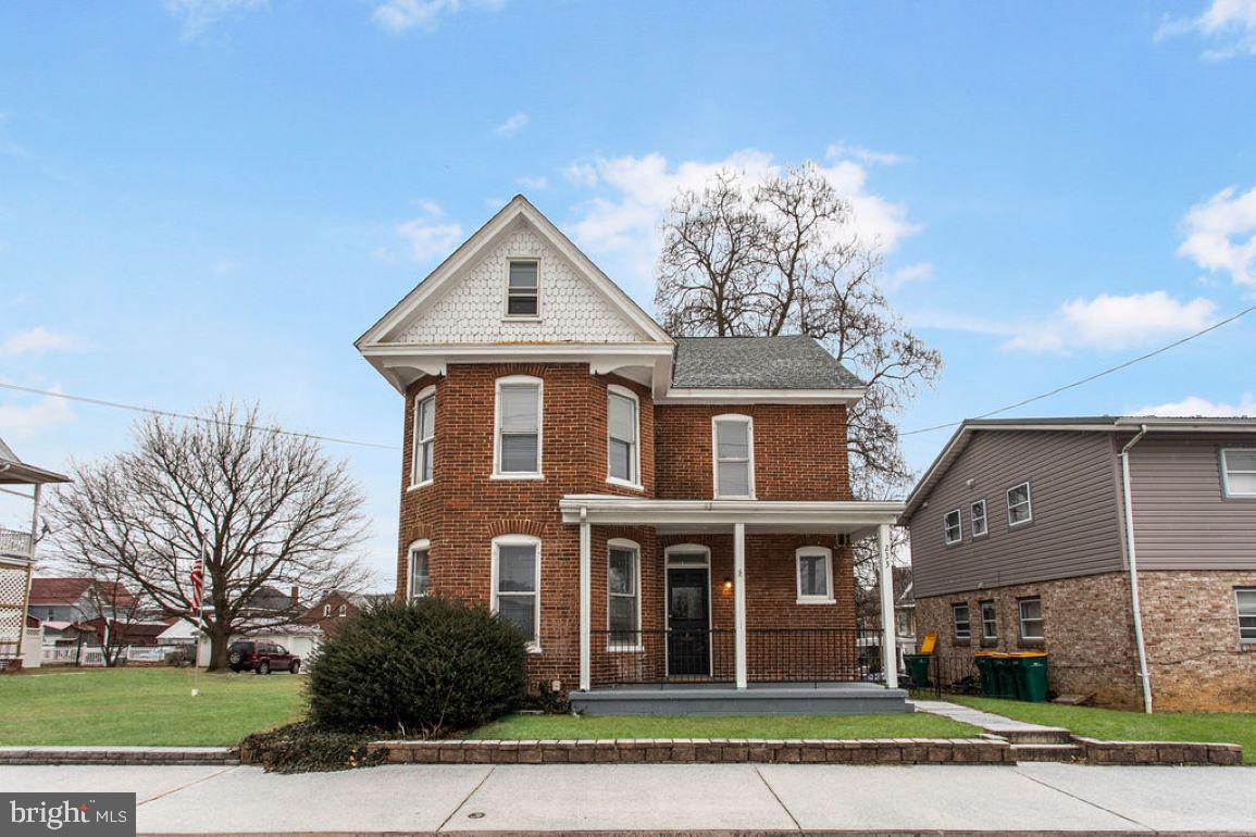 Beautifully updated Victorian home with welcoming front porch.  Living room with original hardwood floors and curved wall of windows, adding to all the charm and character this home offers.  Formal Dining room leads to nice sized kitchen with white cabinets and unique luxury vinyl floor. 1/2 bath and laundry on main level for convenience.   Upstairs, there are 3 nice sized bedrooms, one with access to a balcony overlooking the back yard. Huge walk up attic for storage, plus an unfinished basement for more storage space too!  This beauty won't last long!