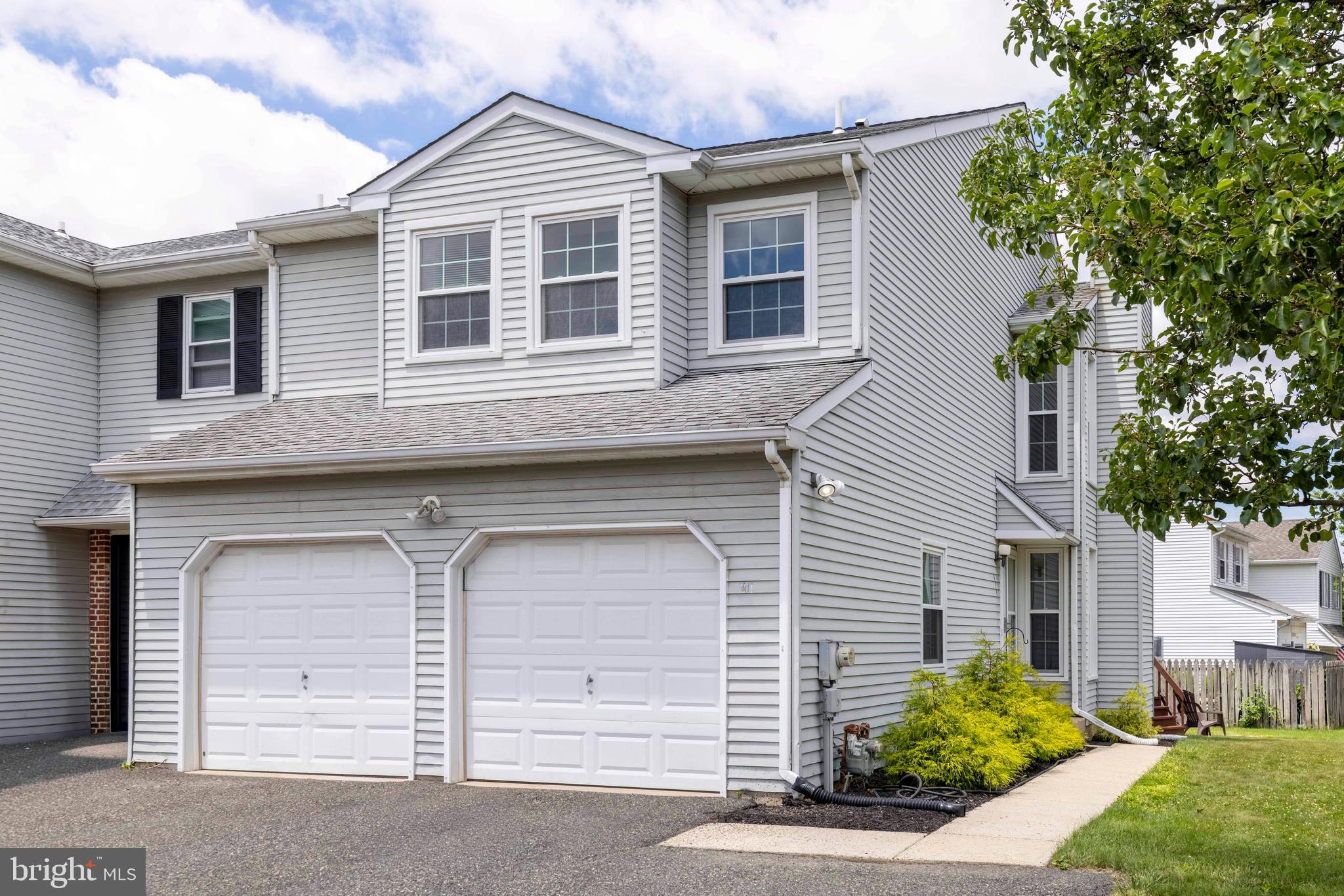 This spacious three-bedroom, two and a half bath end unit townhome is situated on a gorgeous corner lot. It has a 2-car attached garage and off-street parking for 3 cars! The foyer has a double coat closet and opens up to the living room with luxury vinyl plank floors that are throughout the majority of the home. The huge living room features a fireplace, abundant natural light from eight windows, crown molding, and a two-story 17-foot ceiling.  The dining room is a great spot for family and holiday dinners and has a sliding glass door to a deck and opens a spacious kitchen. The kitchen has plenty of cabinet and counter space, a subway tile backsplash and stainless-steel appliances.  A powder room and convenient access to the two-car attached garage completes the first floor. The second floor has brand new carpeting and three generously sized bedrooms and two full baths. The primary bedroom features a dressing area with built in cabinetry, a walk-in closet, an additional closet, and a private bath with a stall shower, built in seat, and large linen closet. Two additional bedrooms share a hall bath, and both have double closets. There is a convenient second floor laundry. The finished lower level with luxury vinyl plank flooring has a large family room, a dedicated office and features multiple storage closets and built in shelving.  The rear deck offers a comfortable space for outdoor dining or relaxing. This townhouse is more like a single-family home-you have plenty of space, a beautiful yard, and a 2 car garage. Conveniently located near shopping, restaurants, baseball and soccer fields, and major roadways such as 309 and the PA Turnpike.