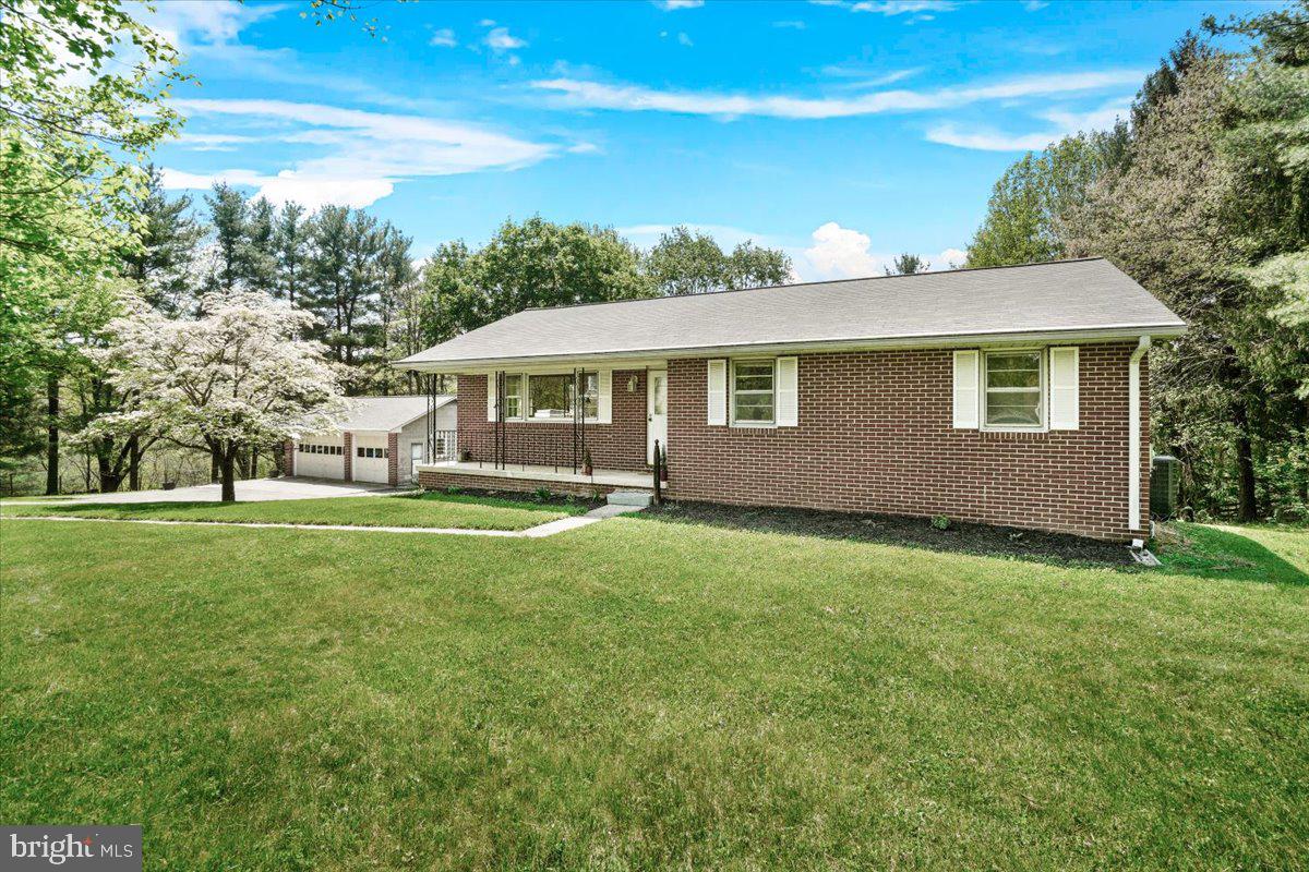 This all brick rancher sitting on 3-1/2 acres on the Carroll County Side of Mount Airy, offers 4 Bedrooms, 2 1/2 Baths, recently remodeled kitchen with new slow close gray cabinets, granite countertops (black) , new stainless steel appliances, breakfast bar, dining room, living room, 3 bedrooms upstairs with hardwood flooring, primary Bedroom has a 1/2 bath, recently remodeled hall bath with new vanity, shower, and toilet.  Downstairs offers a kitchen, living area and a full bedroom with a bath, could be used as an inlaw suite, a utility room, and laundry room, hook up for wood stove.   The house has a newer roof, newer HVAC, all within the last few years.   A 2 Car oversized garage with a pit to work on your cars, electric with 240v, and separate storage underneath the garage.
