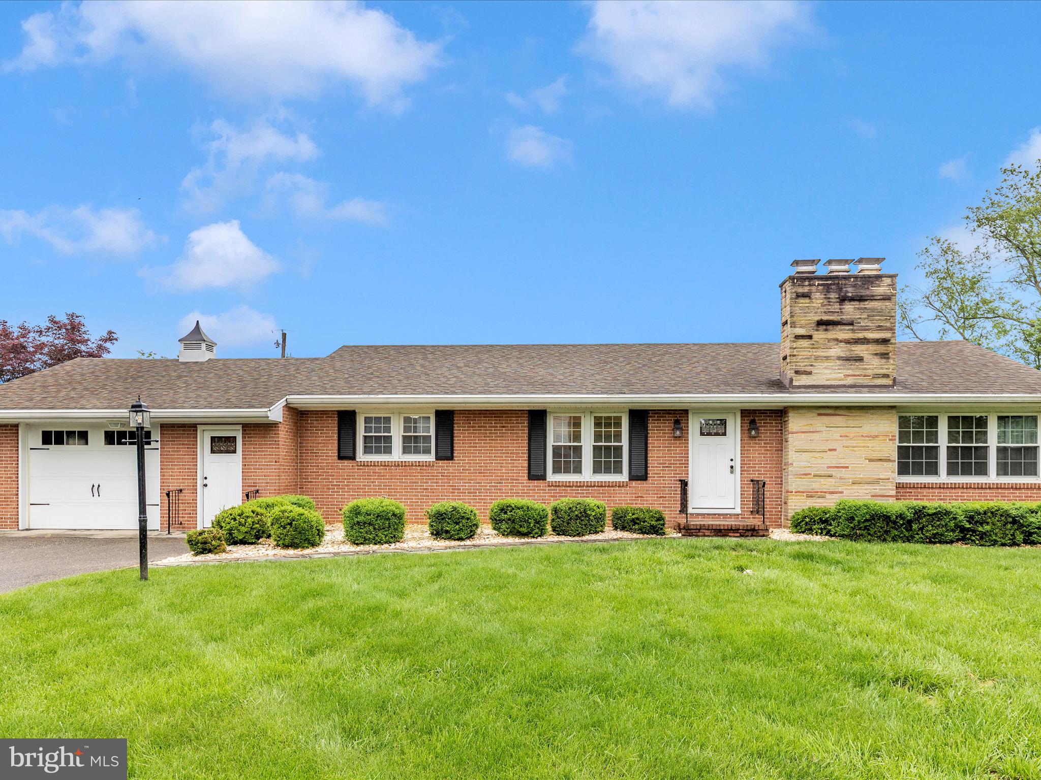 Welcome to 12909 Cathedral Ave. in Hagerstown! This lovely brick rancher is nestled on a beautifully landscaped lot and offers a spacious, well-maintained interior with numerous updates. The main level features a generous living room with a cozy fireplace, a charming dining area with built-in cabinetry, and gleaming hardwood floors throughout. The updated kitchen includes newer appliances, ample cabinetry, and a convenient layout perfect for everyday living and entertaining. A mudroom and main-level laundry add practicality, while the primary bedroom offers a private retreat with its own bath and sitting area. Two additional bedrooms and a full guest bath—featuring a gorgeous walk-in shower—complete the main level.
The finished lower level expands your living space with an in-law or guest suite, including a second kitchen, large family room, fourth bedroom, and another updated full bath. A walkout leads to a private patio space ideal for relaxing or hosting guests. Additional features include a one-car garage, newer windows and roof (replaced in 2014), and a convenient location close to shopping, schools, and commuter routes. This home has been very well cared for and is move-in ready!