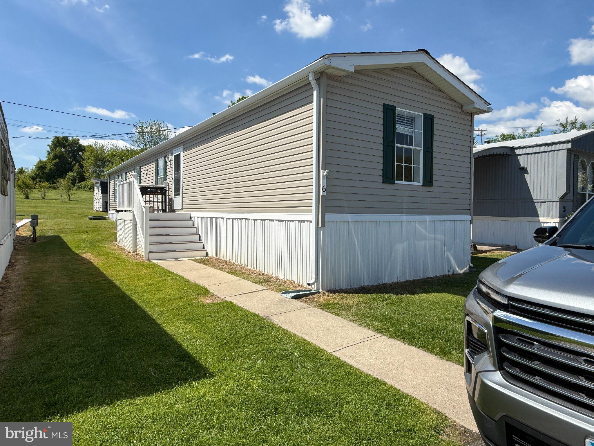 Discover a charming residence nestled within the serene Wrights Manufactured Community, where comfort meets modern living. This meticulously maintained 1973 manufactured home boasts an inviting atmosphere, perfect for those seeking a blend of style and functionality. Step inside to find a spacious open floor plan that seamlessly connects the living, dining, and kitchen areas, creating an ideal space for entertaining or simply enjoying quiet evenings at home. The combination kitchen and dining area is designed for both casual meals and festive gatherings, featuring stainless steel appliances that elevate your culinary experience. The gas oven/range, microwave, and dishwasher ensure that every meal is prepared with ease, while the eat-in kitchen provides a cozy spot for morning coffee or casual dining. With three well-appointed bedrooms and two full bathrooms, this home offers ample space for relaxation and privacy. Each room is enhanced by ceiling fans, promoting a comfortable climate year-round. The excellent condition of the property is evident in its laminated flooring, which adds a touch of elegance while being easy to maintain. Outside, the property features a charming shed, perfect for additional storage or as a workshop for your hobbies. The exterior, clad in durable vinyl siding, ensures longevity and minimal upkeep, allowing you to spend more time enjoying your surroundings. Parking is convenient with on-street options available, making it easy for guests to visit. While this home does not include a pool, the community offers a tranquil environment that encourages outdoor activities and socializing with neighbors. The nearby commuter rail station, located less than a mile away, provides effortless access to the surrounding areas, making it an ideal choice for those who appreciate convenience without sacrificing comfort. Embrace a lifestyle of ease and sophistication in this delightful manufactured home, where every detail has been thoughtfully considered to create a warm and inviting space. Whether you're hosting friends or enjoying a quiet evening, this residence is a true sanctuary that invites you to make lasting memories. Experience the perfect blend of modern amenities and a welcoming community-your new home awaits.