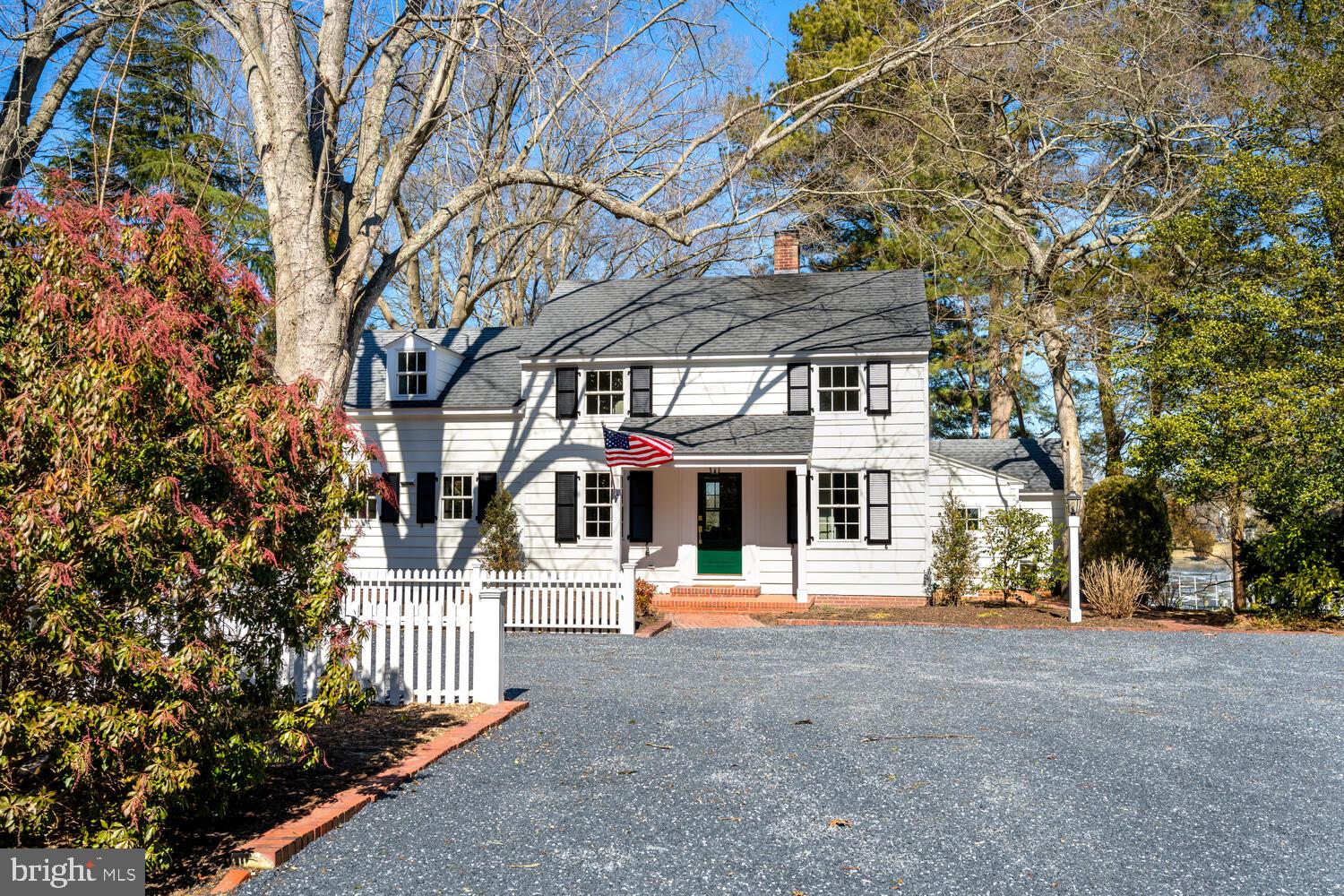 This beautifully renovated home blends historic charm with modern luxury, set on premier 2.75 +/- acres with 150 feet of water frontage, stunning views of Trippe Creek, and direct access to the Tred Avon River. Featuring 3 bedrooms and a versatile bonus room, perfect for a 4th bedroom or office, it's designed for traditional Eastern Shore living.  The main-level primary suite boasts serene water views, a luxurious Carrara marble bath, a furniture-grade vanity, and a frameless glass shower. The chef’s kitchen is equipped with Monogram stainless steel appliances, quartz countertops, soft-close maple cabinetry, and a tumbled marble backsplash.  With every detail of the renovation thoughtfully curated, the interior showcases new White Oak flooring, custom visual comfort lighting, a wood-burning fireplace, Marvin windows, and polished nickel Kohler plumbing fixtures throughout.   The home is also outfitted with high-efficiency Bryant heat pumps, a Rinnai tankless hot water heater, and upgraded electric and plumbing. The dedicated laundry/mudroom features mahogany counters and a farmhouse sink.  Enjoy the outdoors on a screened-in porch with brick flooring, surrounded by mature, lush landscaping in a park-like setting.  There’s room to add a waterside pool, plus a new 120' private pier with a Magnum 12,500-lb boat lift for easy access to all of the local waterways.   A detached two-car garage/accessory structure provides ample storage.  Located off the desirable Oxford Road Corridor, this home is minutes from Oxford and Easton, with the Talbot Country Club just around the corner.   Don’t miss this rare opportunity to own a piece of Talbot County waterfront in one of the Shore’s most prestigious locations.