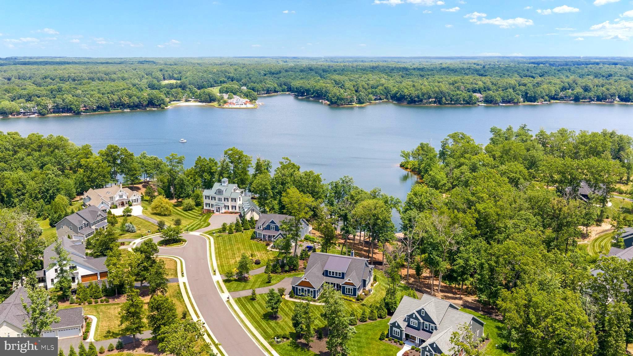 Experience lakefront living at its finest in the prestigious gated community of Fawn Lake. Built by Simply Homes and less than five years old, this stunning Coastal Craftsman showcases exceptional craftsmanship, thoughtful design, and breathtaking sunrise views over the water.

Imagine waking each morning in the luxurious first-floor primary suite, where serene lake views create a peaceful , picture-perfect start to life on the water. Designed for both elegant entertaining and effortless everyday living, this exceptional residence features a gourmet kitchen at the heart of the home, seamlessly flowing into spacious living and dining areas ideal for gatherings. Five spacious bedrooms and five beautifully appointed baths provide comfort and flexibility for family and guests alike.

 Expansive windows capture panoramic water views, while the inviting screened porch provides the perfect setting to enjoy morning coffee and gentle lake breezes. A private elevator offers convenient access to all levels, including the walkout lower level, where a speakeasy creates a one-of-a-kind entertaining experience. 

Upstairs, you will find three additional bedrooms, a spacious loft, and two full baths-offering comfort, flexibility, and room for guests or family to unwind. 

Outside, a scenic stroll leads to your private dock, where endless waterfront adventures await. Spend your days water skiing, fishing, paddleboarding, kayaking, or simply relaxing by the water's edge. 

Perfectly positioned on one of Fawn Lake's most desirable waterfront homesites, this remarkable residence offers the ideal blend of luxury, comfort, and recreation. This is a rare opportunity to own a nearly new custom lakefront retreat where every detail has been carefully curated for exceptional living. 

The Fawn Lake community provides an unparalleled luxury lifestyle with exceptional amenities, including gated 24 hr security, a recreational boating lake, sandy beach, community pool and clubhouse, renowned Arnold Palmer golf course, tennis and pickleball courts, soccer and baseball fields, miles of scenic walking trails, a dog park, marina, on-site restaurants, playgrounds, and a variety of clubs and activities for all ages. Experience the pinnacle of resort-style living, where every day feels like a vacation!