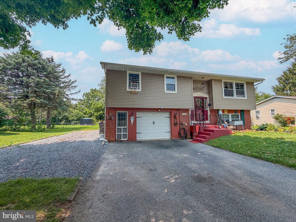 Professional Photos will be coming soon. Welcome to this beautiful country-style 3-bedroom bi-level home located in the heart of Morgantown Proper! This well-maintained home offers a spacious living room and dining room with access to a rear deck featuring a canopy—perfect for relaxing or entertaining. The remodeled kitchen provides modern style and functionality, while the lower level features a cozy family room with a pellet-burning stove, creating the perfect gathering space. You'll also find a convenient laundry room with a powder room and direct access to the oversized garage. Since 2020, the owners have made numerous improvements, including new Andersen windows, a new roof ( with a 50-year shingle), new siding with insulation wrap and new gutters. Additional updates include newer electrical switches and outlets, and plush carpeting installed in December 2025. The hardwired security system will remain with the home for added peace of mind. New owner can elect to subscribe to ADT. Outside, enjoy a flat backyard complete with a children's playground under the deck featuring swings and mulch, as well as two well-maintained storage sheds that are included with the property. The owner has 2 RV hookups. A 30 and 50 amp hook-ups perfect for a contractor or RV owner. The driveway can accommodate 2+ cars, plus a gravel parking spot for an RV. Conveniently located with easy access to the Pennsylvania Turnpike and Route 10, this home is just minutes from local shopping, dining, and everyday amenities. Combining thoughtful updates, comfortable living spaces, and an excellent location, this is a move-in-ready home!