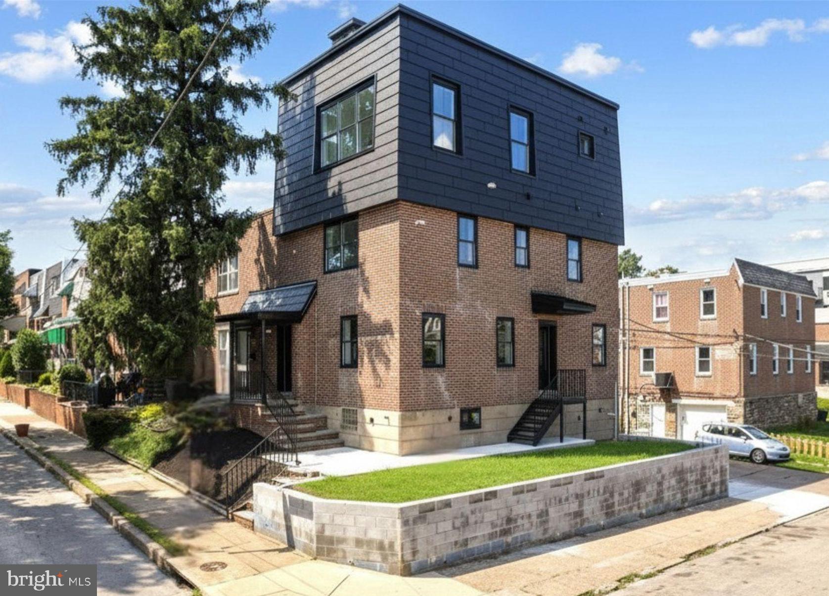 Welcome to 6101 Gardenia Street, a completely reimagined end-of-row townhome on a desirable corner lot in the West Central Germantown neighborhood of Philadelphia. Set on a well-loved, tree-lined block, this exceptional home pairs timeless curb appeal with modern luxury. A classic brick façade, covered front entryway, and private rear driveway with off-street parking for two cars create a warm and inviting first impression.

Completely renovated from top to bottom, every detail has been thoughtfully selected, making this home truly move-in ready. Step inside to engineered hardwood flooring throughout and a sun-drenched, open-concept living room featuring a sleek linear electric fireplace and an abundance of natural light from windows on multiple exposures, a unique advantage of this corner property. Throughout the home, you'll find all-new windows, recessed lighting, and designer finishes that create a bright, sophisticated atmosphere.

The chef's kitchen is designed for both everyday living and entertaining, featuring contemporary white shaker cabinetry, quartz countertops, stainless steel Bosch appliances, under-cabinet lighting, a spacious center island, generous counter space, and abundant storage. A convenient first-floor powder room completes the main level.

The second floor offers two generously sized bedrooms, a beautifully appointed hall bathroom with a tub, and a conveniently located stacked washer and dryer. One bedroom features its own private en-suite bath with a walk-in shower, making it an ideal guest suite or private space for family members.

Occupying the entire third floor, the primary suite is a true private retreat. This expansive sanctuary is flooded with natural light from walls of windows on both sides of the home and features an incredible walk-in closet. The spa-inspired bathroom offers a double vanity, oversized walk-in shower with dual shower heads, soaking tub, and a private water closet. Just outside the suite, a wet bar with a beverage cooler provides the perfect spot for your morning coffee or evening cocktail before stepping onto the spectacular rooftop terrace, an ideal space to relax or entertain under the stars. A conveniently located powder room on this level allows guests to easily access a restroom while enjoying the rooftop without entering the primary suite, making the space perfect for entertaining.

The fully finished walk-out lower level offers incredible flexibility to fit your lifestyle. Whether you envision a media room, home office, fitness space, guest suite, or recreation room, this level delivers. Complete with a wet bar, beverage cooler, full bathroom with a walk-in shower, and a fourth bedroom, it also features its own private rear entrance leading to a custom built-in mudroom, making it an excellent option for multigenerational living, guests, or work-from-home convenience.

Outside, the rear patio offers a unique opportunity to personalize your outdoor living space. Buyers may choose to have the yard professionally sodded or paved for an additional fee and work directly with the builder to create the backyard oasis that best suits their lifestyle.

Residents enjoy easy access to the shops and restaurants along Germantown Avenue, nearby Weaver's Way Co-op, Vernon Park, Awbury Arboretum, and the miles of hiking and biking trails in Wissahickon Valley Park. Commuters will appreciate the nearby regional rail stations, Lincoln Drive, Route 1, and convenient access to Center City, Chestnut Hill, and the surrounding suburbs. Buyers are drawn to Germantown for its rich history, vibrant community, beautiful tree-lined streets, and exceptional value compared to neighboring Northwest Philadelphia communities.