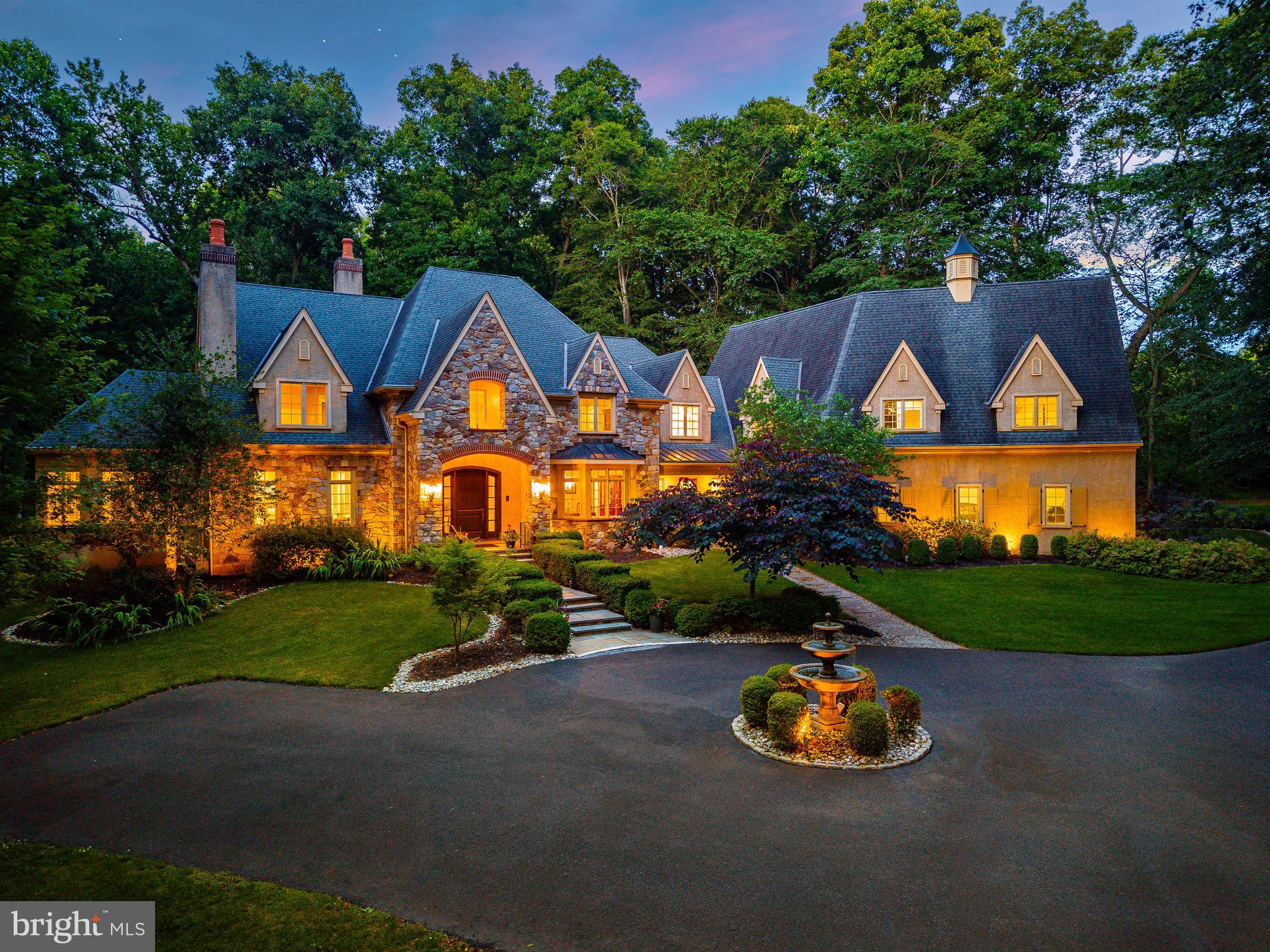 Expertly crafted by the award-winning team at Trueblood Design and Build, this extraordinary estate showcases timeless architecture, exceptional craftsmanship, and meticulous attention to detail throughout. Nestled on 2.45 professionally landscaped acres within the prestigious Stoneymead community, the home offers an unparalleled blend of luxury, comfort, and resort-style living.

A circular drive with a classic fountain welcomes you to the impressive stone façade, setting the tone for the elegance that unfolds inside. A grand two-story foyer showcases a sweeping curved staircase, rich hardwood flooring, custom millwork, extensive built-ins, and beautifully proportioned living spaces designed for both everyday comfort and sophisticated entertaining.

At the center of the home is an exceptional chef's kitchen appointed with custom cabinetry, granite countertops, a substantial center island with prep sink, Wolf six-burner range with griddle, double Wolf wall ovens, warming drawer, Sub-Zero refrigerator, and an expansive breakfast area overlooking the backyard. The kitchen flows seamlessly into a spectacular gathering room with soaring cathedral ceilings, custom walnut built-ins, and a striking fireplace that creates an inviting atmosphere for guests.

Equally impressive is the dramatic two-story great room, where a soaring wall of windows fills the space with natural light while framing breathtaking views of the private grounds. A stunning limestone fireplace anchors the room, creating an elegant setting for entertaining on any scale.

The main level also offers formal living and dining rooms, a handsome executive study, a sun-filled solarium, a butler's pantry with wine storage, spacious laundry room, and two powder rooms.

Designed to rival a luxury resort, the outdoor living spaces are simply extraordinary. Expansive paver terraces surround the Anthony & Sylvan heated pool and spa featuring waterfalls, fountains, and multiple lounging areas, all framed by mature landscaping that creates exceptional privacy. A fully equipped outdoor kitchen with a Dacor built-in grill makes effortless outdoor entertaining possible throughout the seasons.

The luxurious primary suite serves as a private sanctuary featuring a spacious sitting room, dual spa-inspired bathrooms, and custom California Closets. Four additional bedrooms provide exceptional accommodations, including two private ensuite bedrooms and two bedrooms connected by a Jack-and-Jill bath.

The fully finished lower level offers endless flexibility and entertainment with a granite wet bar and kitchenette, billiards area, fitness center, dance studio, playroom, theater-ready media room, full bath, second laundry room, bonus room, wine storage, and abundant storage throughout.

Additional highlights include a heated four-car garage with premium resinous quartz flooring, five-zone HVAC, whole-house audio with indoor and outdoor speakers, central vacuum system, California Closets throughout, and exceptional utility and storage spaces rarely found in homes of this caliber.

Perfectly positioned just minutes from historic Doylestown, New Hope, Lambertville, and Peddler's Village, with convenient access to Routes 202, 413, and 611, this remarkable residence offers the privacy of an estate setting while remaining close to the very best of Bucks County.

A rare offering where timeless elegance, exceptional craftsmanship, and resort-style amenities come together to create a home unlike any other.