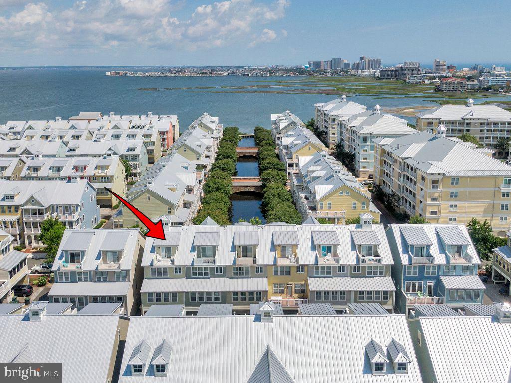 **OVER $40,000 GRI booked for summer 2026**. 

Welcome to 29 Sunset Island Drive—where every day feels like a coastal escape.

Tucked inside the gates of Sunset Island in Ocean City, this waterfront townhome invites you to slow down, breathe in the salt air, and settle into the rhythm of bayfront living. Mornings begin with coffee on a private balcony as the sun rises over the canal, and evenings wind down with glowing sunsets reflected on the water just steps away.

Inside, the home unfolds across four spacious levels, each thoughtfully designed for gathering, relaxing, and making memories. Built with the largest floor plan by NV Homes, there’s room for everyone—whether you're hosting a summer getaway or enjoying a quiet weekend retreat.

The main living level is where life naturally comes together. Conversations flow easily between the open kitchen, dining space, and multiple living areas, while a cozy game nook invites laughter after long beach days. It’s the kind of space where stories are shared, meals linger, and time seems to stretch just a little longer.

Upstairs, the primary suite becomes your personal sanctuary—quiet, comfortable, and removed from it all. Additional guest rooms offer welcoming spaces for family and friends, while the top-floor loft feels like a hidden retreat of its own, perfect for late-night chats, visiting guests, or simply a peaceful moment alone.

Step outside onto one of the home’s many balconies and you’ll feel it instantly—that unmistakable coastal calm. Boats drift by, breezes roll in off the bay, and the pace of everyday life fades into the background.

Beyond your front door, Sunset Island offers a lifestyle that’s just as inviting. Private beaches, pools, walking paths, and a vibrant sense of community make it easy to fill your days—or do nothing at all.

This isn’t just a home—it’s where summer lingers a little longer, and every visit feels like a getaway.