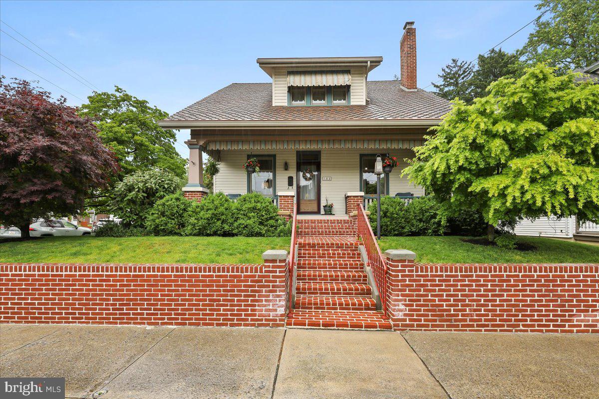 Discover the charm and exquisite character of this Craftsman style home, situated on a beautifully landscaped corner lot in the heart of Manheim. This residence, lovingly and meticulously maintained, offers a delightful blend of classic architecture and modern amenities. This 1.5 story home boasts three bedrooms and 1.5 baths.  A spacious deck with a custom awning provides the ideal spot to savor your morning coffee, while a covered full front porch invites you to relax and enjoy the outdoors. The first floor is adorned with exquisite chestnut woodwork that enhances the home's historical charm. You'll adore the updated kitchen, which combines modern convenience with classic style. It boasts granite countertops, a center island, stainless steel appliances, gas cooking, a pantry, and recessed lighting—ideal for both casual meals and culinary creations. The spacious living room  features a charming window seat and gleaming hardwood floors. This space is perfect for both relaxation and entertaining. For quieter moments, the cozy library room offers a fireplace, providing a perfect spot to read a book and relax.
Host family dinners and entertain guests in the formal dining room, which features stunning built-in chestnut cabinetry that adds both beauty and storage. One of the most remarkable features of this 1920s home is the large walk-in closets in every bedroom, offering ample storage space—a rare find in homes of this era. This home is equipped with a one-car garage, a shed, and a potting shed, offering ample storage and workspace. A whole house generator ensures peace of mind, while efficient gas heat and central air provide year-round comfort. Experience the graceful blend of historic charm and modern convenience at 103 S Hazel St. This Craftsman gem is more than just a house-it’s a place to call home.