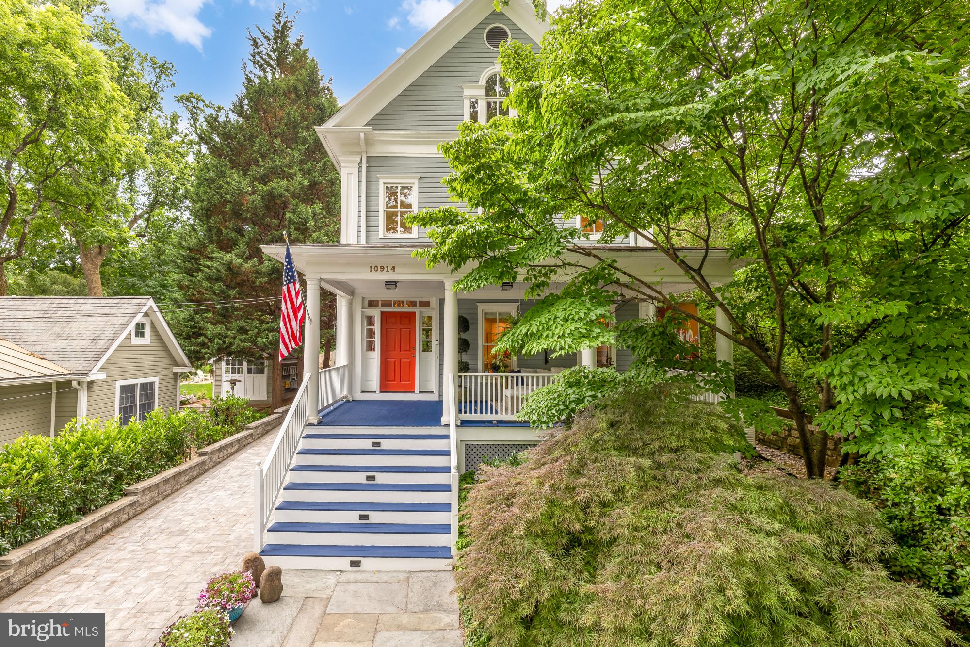 Nestled among mature specimen trees and beautifully curated landscaping in the heart of Garrett Park, this magazine-featured custom-built residence is a masterful blend of architectural character, craftsmanship, and resort-style living. Surrounded by stunning stonework, lush gardens, and an updated swimming pool, the property offers exceptional privacy and tranquility within one of Montgomery County’s most beloved communities.

Designed for both entertaining and everyday living, the main level unfolds through a collection of elegant yet inviting spaces. A gracious formal living room anchored by a fireplace and custom built-ins creates a warm gathering place, while the elegant dining room is perfectly suited for intimate dinners and larger celebrations. At the center of the home, the expansive chef’s kitchen features a substantial center island, abundant custom cabinetry, a built-in wet bar, and a sun-filled breakfast area overlooking the grounds. Just beyond, the spectacular family room is flooded with natural light through walls of windows and French doors that frame picturesque views of the backyard oasis. The seamless connection between indoor and outdoor living makes this space ideal for entertaining, relaxing, and everyday enjoyment. A striking spiral staircase adds architectural interest while providing private access between the family room and the primary suite above.

The upper level is anchored by an extraordinary primary retreat that feels more like a boutique hotel suite than a traditional bedroom. Vaulted ceilings create a dramatic sense of scale, while a fireplace adds warmth and sophistication. French doors open to a private balcony overlooking the beautifully landscaped grounds and swimming pool below. The spacious primary bath features elegant finishes, a soaking tub, separate shower, and generous proportions throughout. Three additional bedrooms and two full baths complete this level, providing ample accommodations for family and guests.

The finished third floor offers exceptional flexibility with a private bedroom and full bath, making it ideal for guests, an au pair suite, home office, creative studio, or additional living space. The lower level serves as a private recreation and wellness retreat, featuring an expansive fitness area complete with a sauna and cold plunge, a spacious game room, dedicated study, abundant storage, and a beautifully redesigned laundry room. Together, these spaces provide exceptional flexibility for work, recreation, and relaxation.

Outside, the grounds are every bit as impressive as the home itself. Mature landscaping, extensive stonework, and an updated swimming pool create a resort-like setting rarely found in the area. Whether hosting summer gatherings poolside, dining beneath the canopy of trees, or simply enjoying the serenity of the gardens, the outdoor spaces offer a true sense of escape. A detached one-car garage is complemented by a handsome paver driveway that provides ample parking for guests.

The property has benefited from extensive recent improvements, including a new roof, renovated bathrooms, upgraded lighting throughout, two replaced HVAC systems, a whole-house generator, redesigned laundry room, driveway replacement, pool enhancements, exterior painting, new rear glass doors and windows, and numerous additional updates that reflect exceptional care and investment over the years.

Residents enjoy Garrett Park’s unique small-town atmosphere with winding tree-lined streets, historic charm, and strong sense of community. Nearby Penn Place is home to the beloved Black Market Bistro and historic post office, while the Garrett Park MARC station provides convenient access to Washington, DC. Community amenities include parks, playgrounds, tennis and basketball courts, the Garrett Park Pool, and year-round neighborhood events that make this one of the region’s most distinctive places to call home. This is truly one of the areas best kept secrets!