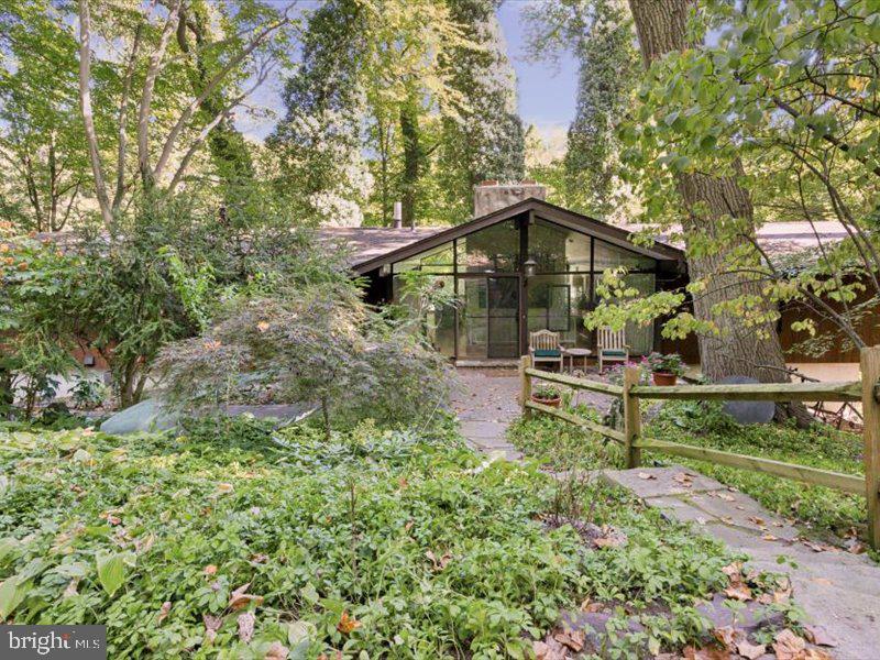 Nestled on a woodland setting on a quiet cul de sac in Haverford in Lower Merion Township,  is one of McElroy’s compelling contemporary homes. With its spectacular treetop views, and overlooking a picturesque  waterfall and pristine Mill Creek,  204 Dove Lane takes wonderful advantage of nature with calming sounds of rushing water while enjoying the exquisite change of seasons. Within the home you will feel connected to the natural world around you whether a forest ablaze with autumnal color to a winter wonderland to  spring and summer months with the woods in bloom.  This 4 bedroom, 2 full bath, 2 half bath home has an easy open floor plan with the principal bedroom located on the main floor, spacious rooms, high ceilings and yet cozy nooks – perfect for everyone, whether socializing and entertaining or quiet space for work or reading a book. Outdoor balconies offer wonderful spots to enjoy dinner or morning coffee. The lower level provides extra bedrooms, guest rooms or office space and surround a second common area to gather. This very private lane has only one fellow home and boasts the excellent Lower Merion schools.   Come and celebrate living with the beauty this wonderful home has to offer!