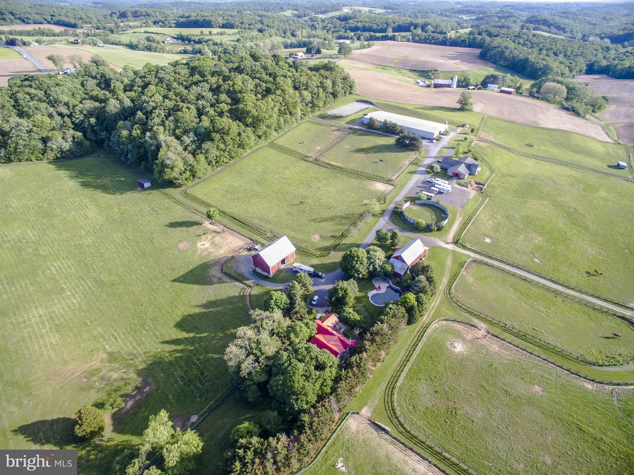 An outstanding equestrian/training facility located in the heart of Baltimore County horse country. Lighted indoor arena; outdoor dressage ring; outdoor 125 x 225 jump ring; 75' diameter round pen; 40 jump cross country schooling course w/water; 35 12 x 12 rubber matted stalls; 3 tack rooms; hot water wash stalls; lush turnout; guest house & barn apartment; main house w/pool.