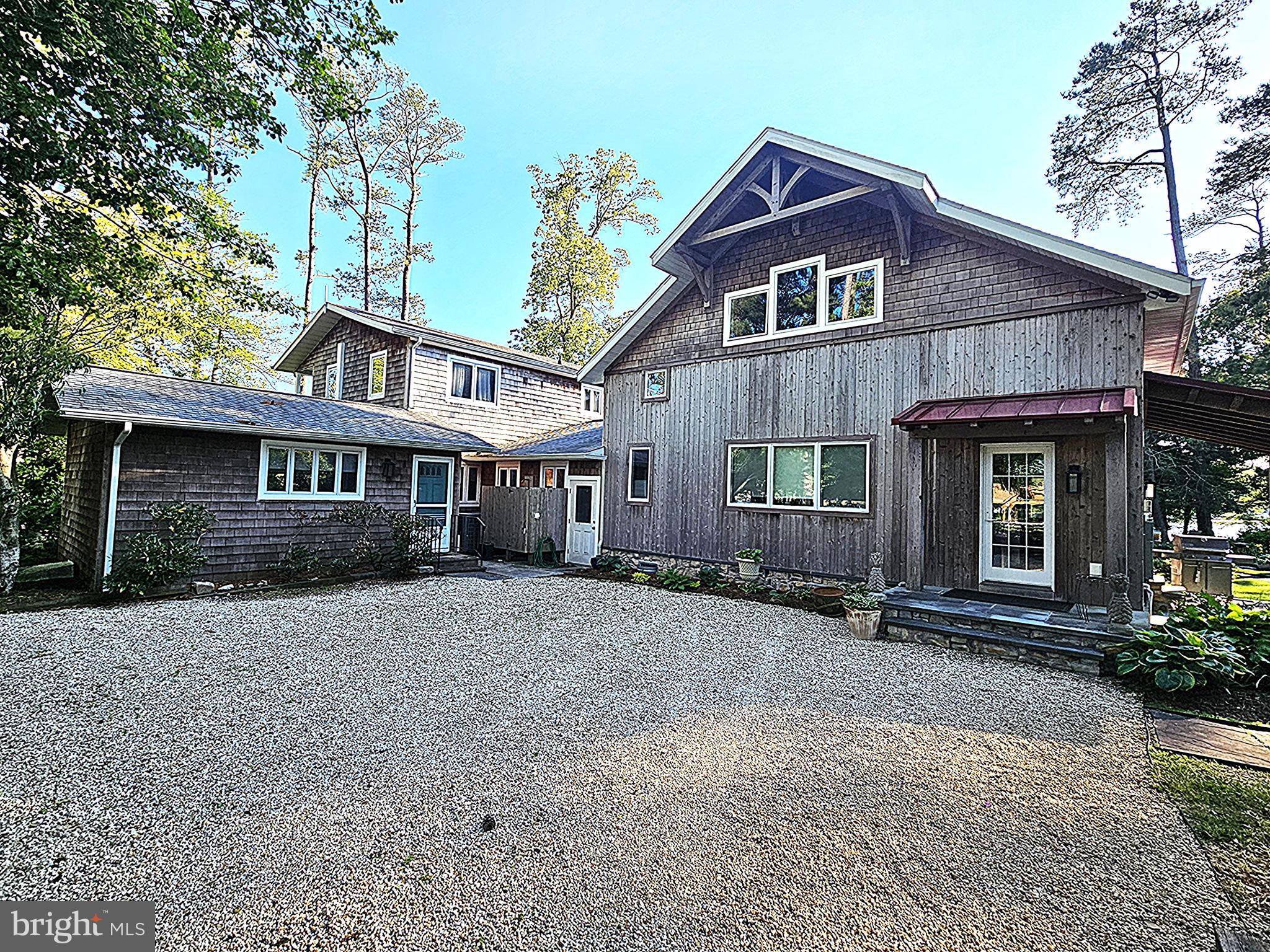 Welcome to 15 Pinewater Dr. This is an amazing home to see that has 554' of waterfront property.  The original home was built in 1974 were  the main entrance to the home is.  In 2010 a 2nd floor was added to the house and in 2018 the Hugh Family room was added on to the house.  In the same year the barn was built and still a work in progress.  This house features an amazing Great room/Family Room with high beams built by the Amish and Graulich builders.  There is not one screw or nail in it because it held together with pegs.  It features stained glass windows, new shades, gas fireplace, kitchen and loft above the kitchen which is currently used as a sewing room . The kitchen has been updated with SS appliances, and granite countertops. The primary bedroom and bathroom are on the first floor, a 2nd full bathroom  and bedrooms 2 and 3. On the 2nd floor it contains bedrooms 4,5,and 6 as well as the 3rd full bath.  There is also a sitting room and balcony that overlooks Burton Prong.  This house also features a formal dining room,  living room,  a sun/Florida room and a screened porch that overlooks the waterfront with panoramic views of Burton Prong. There is a detached barn/garage that features multiple rooms a  bathroom with water and plenty of storage on the 2nd floor. The boat dock was updated this year and a boat lift for a wave runner.    The landscaping is just beautiful the peace and tranquility it offers among the beautiful gardens and trees spread throughout the property. This is a home that pictures just can't describe it.  It's a home you just have to see to appreciate.