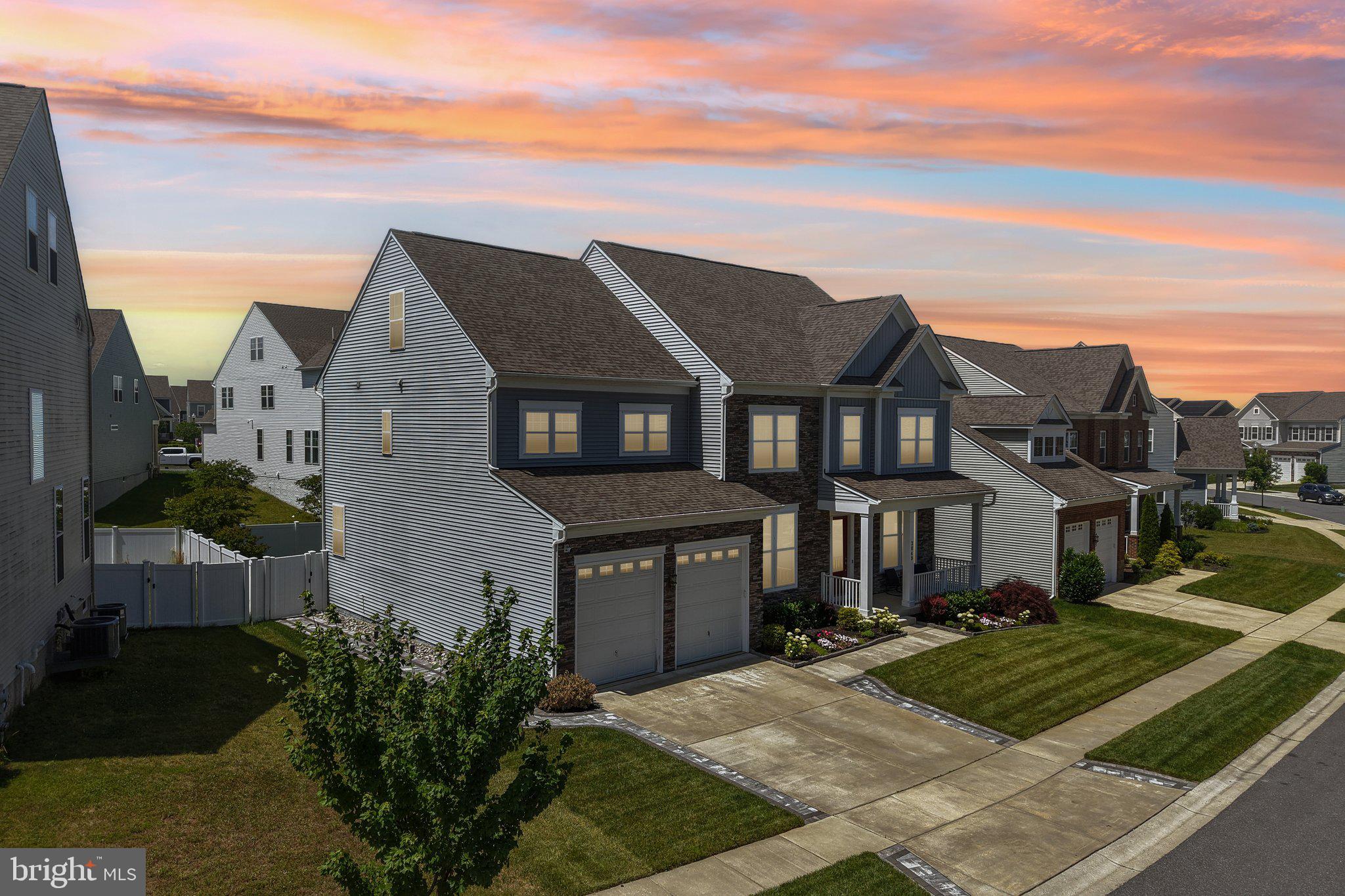 Welcome to 2849 Broad Wing Drive, an exceptional four-level luxury residence located in the highly sought-after Two Rivers community of Odenton. Designed with today's discerning buyer in mind, this move-in ready home offers 5 bedrooms, 5.5 bathrooms, upscale finishes, and resort-style living at its finest.

A charming front porch and beautifully landscaped yard welcome you inside, where luxury vinyl plank flooring flows throughout the main level. The elegant formal dining room features crown molding, chair railing, and shadow box trim, while a private office provides the perfect work-from-home space.

The stunning chef's kitchen is the centerpiece of the home, boasting quartz countertops, a massive center island with pendant lighting and seating, designer cabinetry with illuminated display lighting, 2 ovens, stainless steel appliances, farmhouse sink, wine refrigerator, decorative backsplash, recessed lighting, and a spacious walk-in pantry. Just off the kitchen is a sun-filled morning room and an additional flex space with custom cabinetry, ideal for a second office, homework station, or lounge.

The spacious family room showcases a dramatic floor-to-ceiling stone gas fireplace and elegant tray ceilings with recessed lighting. A mudroom with built-in storage leads to the oversized two-car garage featuring custom non-slip flooring, while a stylish powder room completes the main level.

The luxurious primary suite offers a sitting area, crown molding, two custom walk-in closets, and a spa-inspired bath featuring an oversized waterfall shower, soaking tub, designer tile, and dual vanities. Three additional spacious bedrooms occupy this level, all with walk-in closets, including one with a private en-suite bath. A beautifully appointed hall bath and conveniently located laundry room with utility sink complete the level.

The fourth floor provides exceptional flexibility with a loft, full bathroom, spacious bedroom with walk-in closet, and an incredible rooftop deck perfect for relaxing or entertaining.

The finished walkout lower level offers an expansive recreation area, full bathroom, dedicated fitness room or optional sixth bedroom, recessed lighting, and a rough-in for a future wet bar.

Outdoor living is equally impressive with a huge low-maintenance deck featuring illuminated post caps and walk-down stairs, a custom gray stone patio with built-in seating, professionally designed landscape lighting, a fully fenced flat backyard, and mature landscaping.

Additional features include dual-zone HVAC, lawn irrigation system, CAT 6 wiring throughout, high-end blinds, and four exterior security cameras.  SEE 3D TOUR and VIDEO TOUR

Residents of Two Rivers enjoy resort-style amenities including a clubhouse, fitness center, outdoor pool, community lake, tennis, pickleball, volleyball, indoor and outdoor basketball courts, dog park, playgrounds, and miles of walking and biking trails. Conveniently located near Fort Meade, major commuter routes, shopping, and dining, this extraordinary home delivers luxury, comfort, and an unmatched lifestyle.

Some photos have been virtually staged.