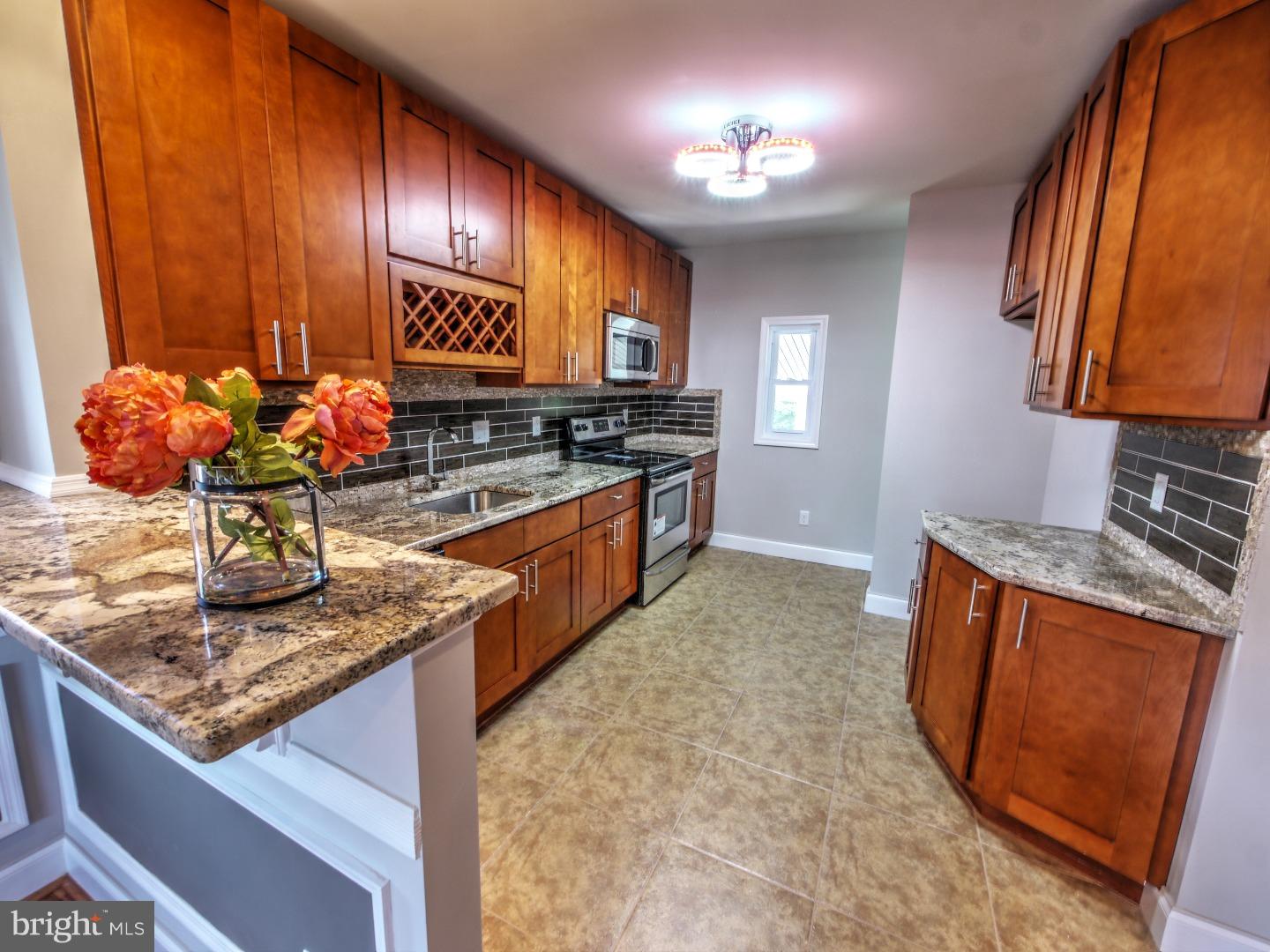 Tucked away on a quiet street in the Hollywood section of Jenkintown, this 3 bedroom 2 bath home has been completely renovated and is just waiting for your personal touches!  Enter through the covered front porch into the open-layout living and dining areas where you'll find beautifully refinished parquet floors, decorative fireplace, custom chair and base molding, and wall frames.  The knockout kitchen features brand new cabinets, lavish backsplash and imported tile floor, granite countertops, breakfast bar, wine rack, and stainless steel appliances (range, dishwasher, microwave).  Three nice sized bedrooms and a shared hall bath, where everything from tiles to vanity to tub is brand new, complete the main floor.  The newly carpeted basement offers a large area for entertaining or relaxing, an additional full bath, laundry room, and plenty of space for storage.  Don't overlook the warm designer colors and abundance of sunlight throughout, a huge rear yard, detached shed, rear covered patio, all new plumbing and electric, brand new central air HVAC system and efficient water heater.  Close to shopping, train station and public transportation, this spectacular home located in the award winning Abington school district has it all!  Disclosure:  Broker has financial interest. Driveway not included.
