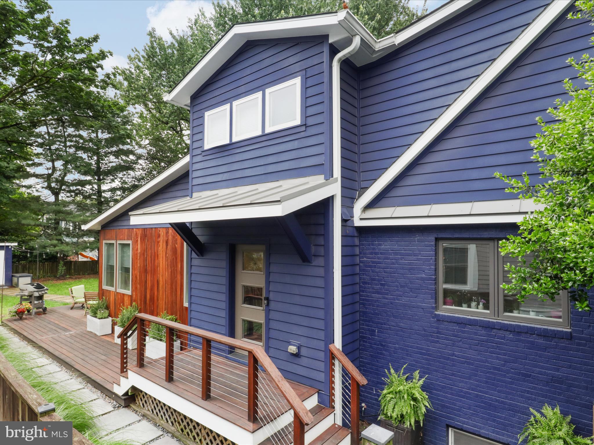 Welcome to 6230 N 21st Street, a modernized classic Cape Cod nestled in the heart of North Arlington’s coveted Highland Park–Overlee Knolls neighborhood. With a seamless combination of elevated design and modern functionality, this residence is truly a rare opportunity in one of Arlington’s most desirable communities.  A short walk to Westover Village and the East Falls Church Metro, experience 3302 square feet of finished living space combining timeless charm with luxurious, high-end finishes, offering both everyday comfort and sophisticated design. 

A major transformation in 2017–2018 introduced a spacious Great Room, a dedicated home office with private entrance, a luxurious primary suite, and a practical side entry/mudroom. Designed for today’s busy households, the side entrance features tile flooring, custom built-in cubbies, generous storage space, and a powder room—an ideal space to keep daily life organized and tidy.

The main level welcomes you with natural light and a dramatic step-down Great Room boasting 10-foot ceilings, creating an expansive setting for everyday living and entertaining. An elegant dry bar thoughtfully connects the Great Room, kitchen and formal living and dining areas, making entertaining seamless and stylish. 

The fully renovated kitchen is a true culinary haven, featuring Brookhaven cabinetry, Silestone countertops, an oversized Blanco sink, and a professional-grade GE Café gas double oven range. With a center island, counter seating, two pantry closets, and a cozy, light-filled breakfast nook, this space is as functional as it is beautiful.

Ideal for modern living, the main level also features a private home office  with its own exterior entrance. The space is flooded with natural light and enjoys views of the deck and yard—perfect for work-from-home professionals, providing a rare and practical space for meeting clients or working in privacy.

Upstairs, the grand primary suite provides a true retreat. Spacious enough for a king-sized bed with ample room to spare, this sanctuary includes both a walk-in closet and an additional reach-in closet. The en suite bath is a showstopper, with a custom walnut dual-sink vanity, Duravit sinks, concrete countertops, and a luxurious walk-in shower accented by sophisticated tile selections.

Two additional bedrooms on the upper level share an updated hall bath featuring a Duravit Vanity, penny tile flooring, a tub/shower combo, and a solar tube for natural light. A bright and open nook offers an ideal space for a second home office or homework hub. This flexible space could also be enclosed, creating a fourth room with a closet and window.

The lower level offers even more versatility, featuring a comfortable finished living area with natural light, a full bathroom, and a generously sized unfinished storage room with built-in shelving and a second refrigerator. This level could serve as a fourth bedroom suite, guest quarters, recreation room, or fitness studio—whatever suits your needs.

Throughout the main and upper levels, gleaming hardwood floors add warmth and continuity, while a wood-burning fireplace in the living room enhances the home’s cozy charm. A dual heating system ensures year-round comfort, and the home has been freshly painted, creating a bright and welcoming atmosphere.

Outdoor living shines here, with a massive IPE wood deck and matching siding offering unmatched durability and aesthetic appeal. The screened-in porch, added in 2021, is outfitted with built-in Infratech heaters for four-season enjoyment, making it a true extension of the interior living space. The flat, fully fenced backyard is perfect for entertaining, gardening, or play.

Ideally situated within walking distance of parks, top-rated Arlington Schools, Westover shops and the East Falls Church Metro, this exceptional home blends classic Arlington charm with modern architectural design, providing the space, style and sophistication today’s buyers seek.