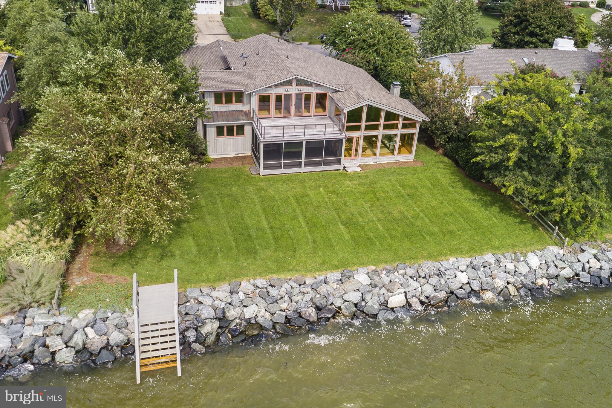 Stunning and unique contemporary home with exposed beams was completely renovated 10 years ago. One of a kind 3600 sq ft home with 100 feet of waterfront and incomparable views of the South River. Fabulous baths with procelain tile, gourmet kitchen, custom doors & lighting, red oak floors, pine and cedar walls & HVAC replaced in 2014. Waterfront screened porch, rip wrap and stairs to waterfront.