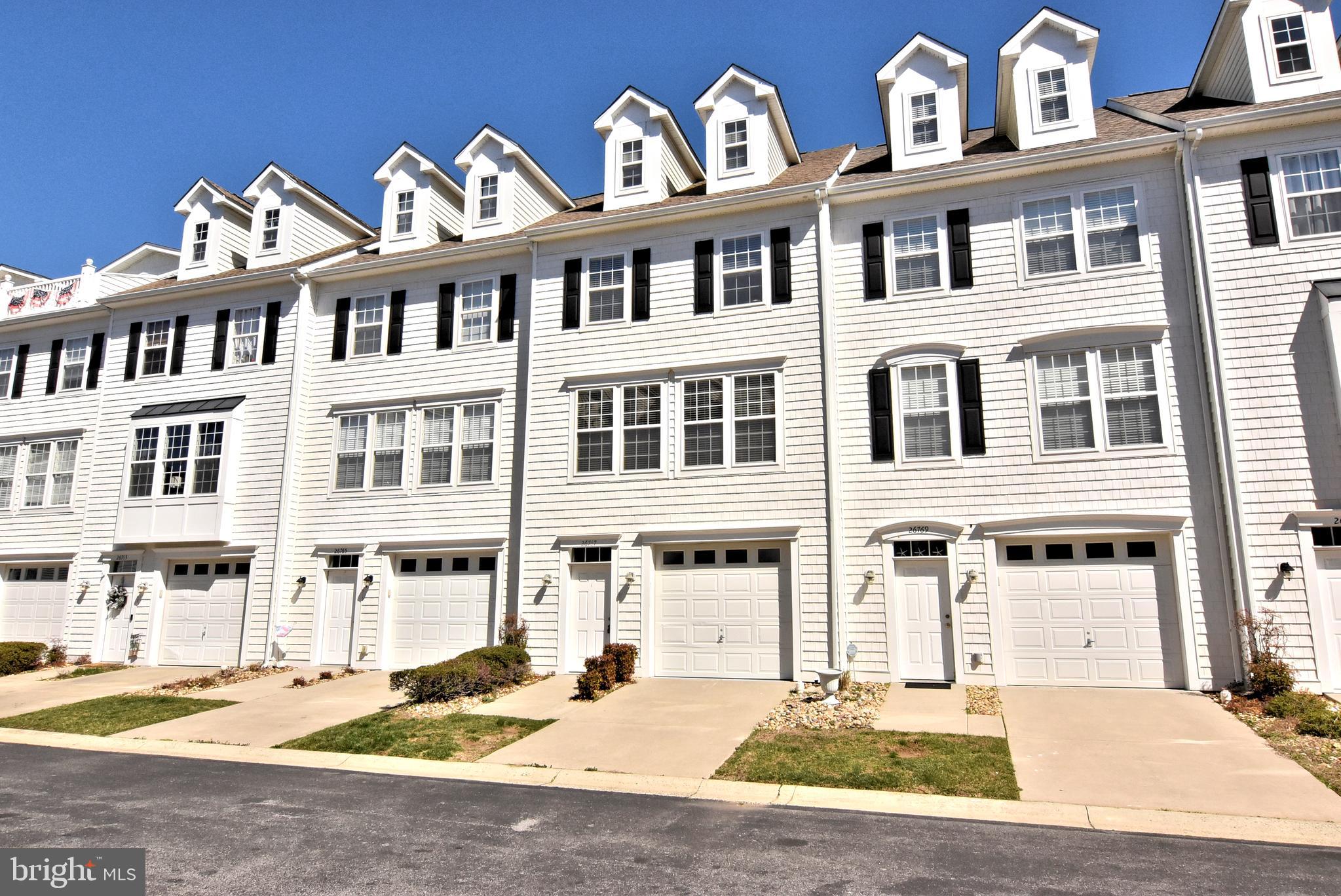 The townhouse at 26767 Chatham Lane, Unit B19-5, in Millsboro, Delaware, is ideally situated for those seeking proximity to water-based recreation, dining, and entertainment options. Located on the Long Neck peninsula, this property is just minutes away from Delaware's coastal towns, including Rehoboth Beach and Lewes, offering easy access to public boat slips on the Indian River and Rehoboth Bay. Residents can enjoy activities such as boating, sailing, fishing, and crabbing. Additionally, the area boasts tax-free shopping at unique local shops and the Tanger Outlets, as well as access to superb medical facilities and championship golf courses. This spacious three-level townhouse features an open-concept floor plan connecting the kitchen, dining, and living areas, making it ideal for entertaining. The primary ensuite bedroom includes a soaking tub and ample closet space, while the top floor boasts a large loft with a bathroom and a terrace suitable for outdoor dining. As part of the Fairfield at Long Neck community, residents have access to a community pool for relaxation and exercise. Given its location and amenities, this property is well-suited for use as a vacation retreat, rental investment, or full-time residence. Its proximity to water recreation activities and entertainment venues enhances its appeal to both residents and potential renters. Sellers will deliver home with new fridge and oven by closing or provide credit at closing to buyer.