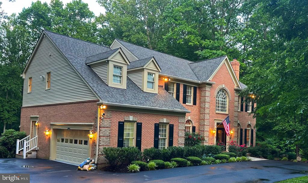 Stately 3 level brick home, turn key, close to everything, with total privacy on a gorgeous lot in the enclosed, highly sought after Devereux Manor and one of the smallest in the neighborhood. Home sits on a premium 5.01 acres with a stream and backyard suitable for a pool, entertaining 200 or your own peaceful oasis. Dramatic 10' ceilings with 2 wood burning fireplaces on the main level which was gutted down to the studs in 2012 and completely updated with hardwood floors, solid cherry cabinets, entertainment center, custom granite counter tops, gourmet kitchen and Wolf oven. Entire house renovation with geo-thermal system, new roof, septic, driveway and enclosed, two story treehouse with power and WiFi for viewing the abundant wildlife, playing cards or sleep overs. Large, finished, newly carpeted, painted and walk-out basement. Master suite 18 foot ceiling, sitting room, totally refurbished, stunning bathroom with marble, shower for two and tub. All new carpet and neutral paint throughout as well as two car, high ceiling garage with custom storage shelves. 3 of the 5 acres has an invisible dog fence. All mounted TV's and accompanying sound systems will convey and several unique pieces of furniture possible to convey also.
