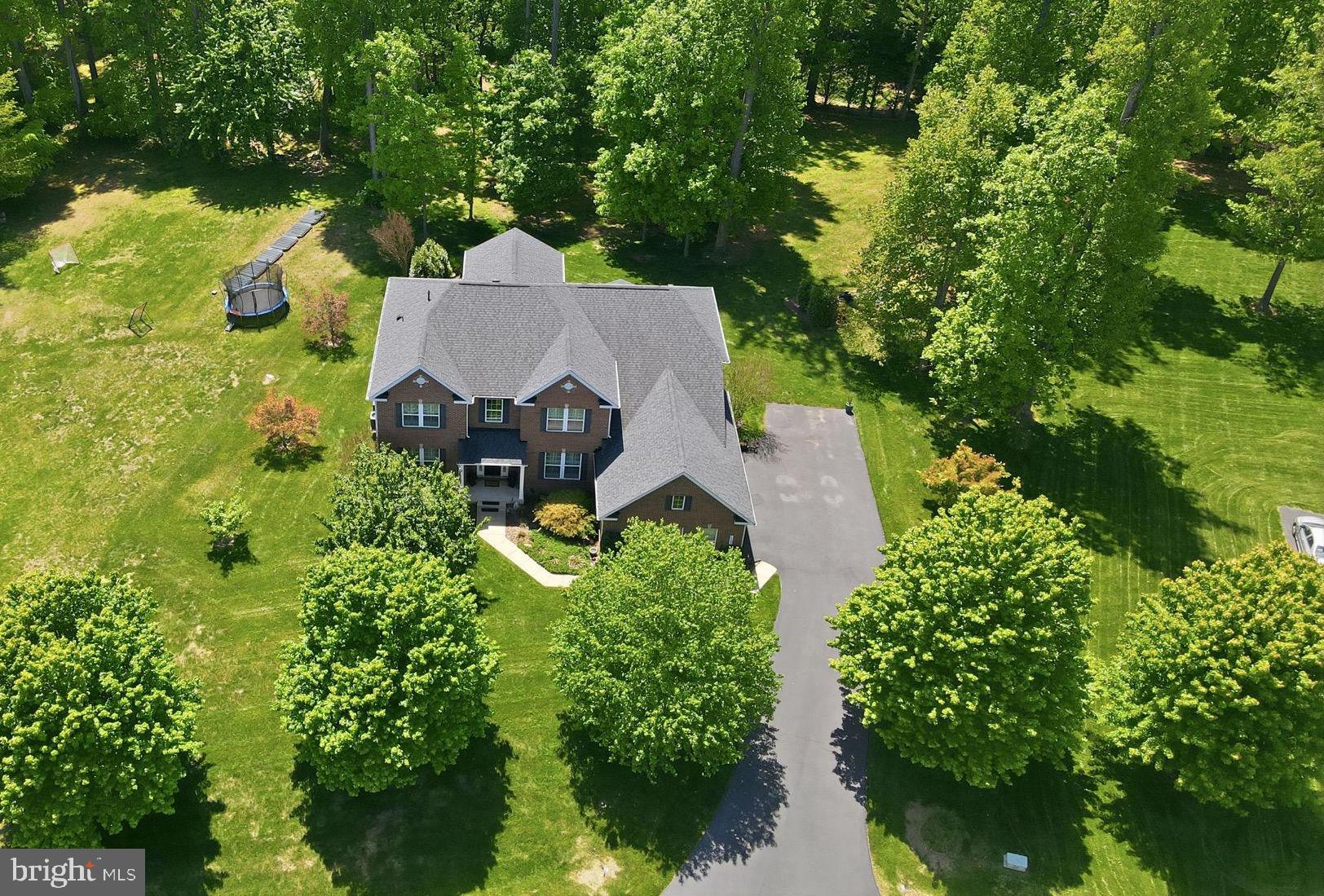 Tucked away on a private .91-acre lot in the picturesque community of Jamison Farms,
this beautifully maintained Heath Model by Richmond American Homes offers the
perfect blend of timeless design, quality construction, and thoughtful upgrades
throughout. Built in 2012 and meticulously cared for by the original owners, this 5-
bedroom, 4.5-bath home with a 3-car side-load garage showcases pride of ownership at
every turn.
Designed with both everyday living and entertaining in mind, the main level features 10-
foot ceilings, Century Farm hand-sculpted 5” hardwood flooring, a formal living room,
dining room, private home office, spacious family room, sunroom bump-out, mud room,
and separate laundry area. The gourmet kitchen is the heart of the home, complete with
a large center island, granite countertops, GE Profile appliances, and seamless flow into
the family room with cozy gas fireplace, and the sunroom bump out with a vaulted 12-
foot ceilings, and windows that flood the space with natural light. Step outside to the
maintenance-free composite deck with integrated Bose speakers, overlooking the
private backyard oasis featuring a custom flagstone fire pit, mature landscaping, and
flower gardens, an ideal setting for relaxing evenings or entertaining guests.
Upstairs, the expansive owner’s suite offers a peaceful retreat with a coffered ceiling,
private sitting area with gas fireplace, dual walk-in closets, and bath with soaking tub,
oversized shower, and dual vanities. Three additional spacious bedrooms and 2 full
bathrooms complete the upper level.
The fully finished lower level offers exceptional additional living space with 9-foot
ceilings, a large recreation room, hobby room, legal fifth bedroom, full bath, and two
oversized storage areas, all designed to feel bright and inviting rather than below grade.
Notable updates and features include a premium architectural shingle roof (2018),
brand new upgraded carpet and pad (2026), first-floor HVAC replacement (2021), water
heater replacement (2021), 9-zone irrigation system, French drain surrounding the
home, industrial sump pump system with automatic flood pump-out requiring no
electricity, double-beveled wood-framed windows throughout, Plantation shutters on all
front facing windows, Surround sound integrated speakers, and 2x6 exterior wall
construction for enhanced quality and efficiency. *Please see our full upgrade list in
documents*
Located in one of Warrenton’s most sought-after neighborhoods known for its estate-
style homes, larger private lots, and beautiful setting, this exceptional property offers the
rare combination of luxury, comfort, and meticulous upkeep.