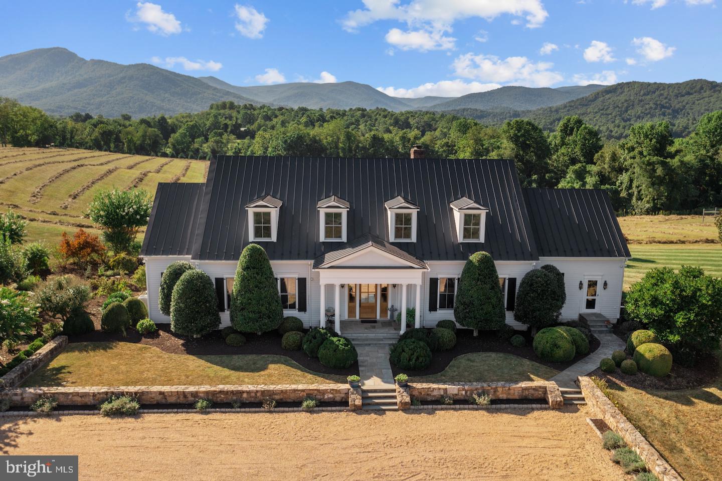 In a county known far and wide for its breathtaking scenic beauty, MorningSide may have the best setting in all of Rappahannock County. The pastoral meadows surrounding the home offer sweeping views of the storied Blue Ridge Mountains from Front Royal to Madison. Anchoring this dramatic 50-mile horizon is the craggy peak of Old Rag Mountain dominating the foreground. From solar energy and geothermal heating to delightful architectural detailing and lovely ornamental gardens, no detail has been spared. The result is an easy living jewel of a home that sits gently on the land. The impeccable main house is spacious, open and beautifully appointed with a fantastic kitchen, comfortable sitting and dining areas, multiple outdoor spaces, four bedrooms, four and a half baths and a full basement with a state-of-the-art gym. This impressive property includes a delightful two-bedroom guest house, garage with studio/sleeping quarters above, two vineyards, home orchard, lovely lawns and some of the best views in the eastern US.