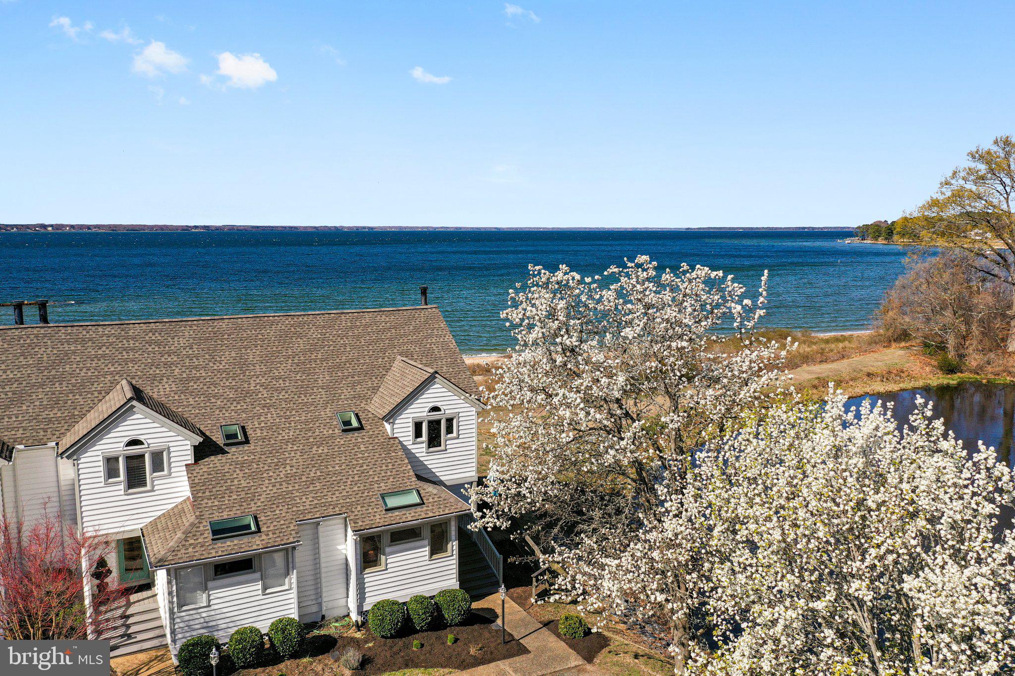Stunning water views of the Rappahannock River await you. This property combines comfort, style, and low-maintenance living, offering an unparalleled lifestyle. Nestled in a picturesque setting, this charming townhome features two spacious bedrooms and two full bathrooms. The inviting kitchen includes a kitchenbar area, perfect for casual meals or entertaining, and seamlessly opens to the great room combining living and dining space. The great room offers tons of natural light, boasts a cathedral ceiling and a wood-burning fireplace, creating a warm and inviting atmosphere. Step out onto the waterside deck to enjoy breathtaking views, watch sailboats drift by, and witness stunning sunsets. As a corner unit with Southern exposure, this home is uniquely positioned to provide wrap-around water views on two sides, offering serene vistas of both the community pond and the Rappahannock River right from your home. Living in this community means access to incredible amenities, including a gorgeous sand beach, a fishing pier, a swimming pool, and tennis courts for staying active and engaged. This home is equipped with two brand new heat pumps, a new water heater, and a new roof installed in 2023. Conveniently located close to a variety of restaurants, shops and more, this townhome offers both a serene retreat and easy access to the vibrant local community. Experience the best of waterfront living in White Stone, VA, where comfort, convenience, and natural beauty come together in perfect harmony.  Breezeline Broadband Internet Available.