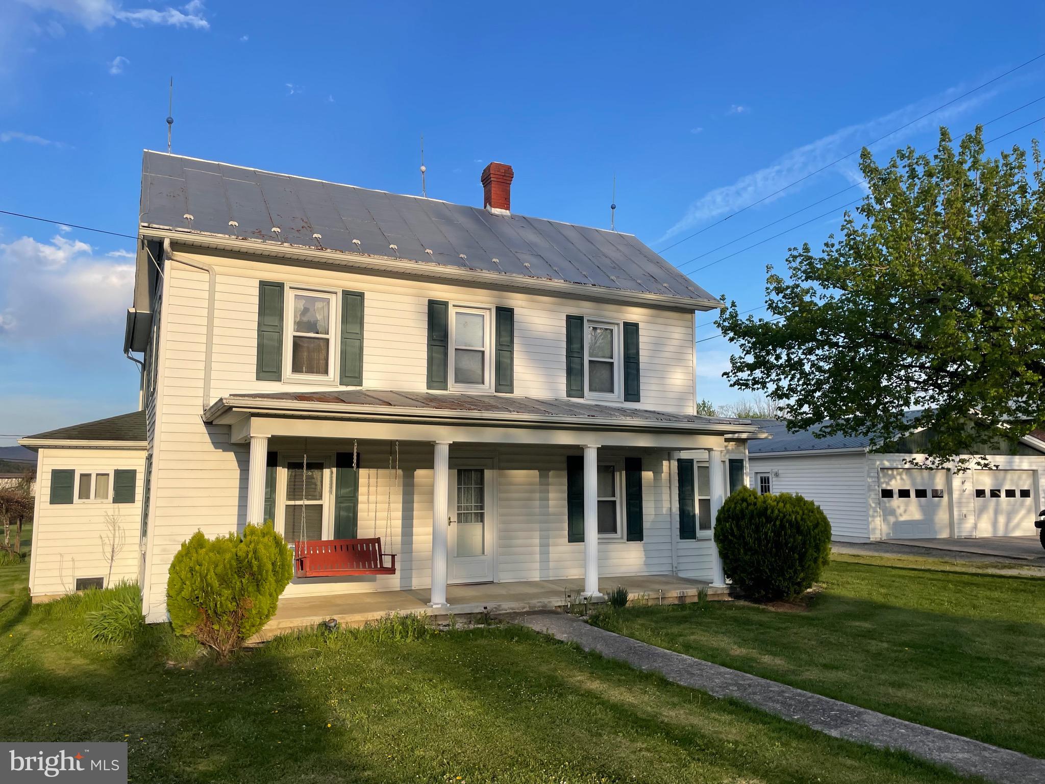 Old country home with original oak paneling on .48 acre, 2 garages, 2 outbuildings, city water, central heat/air, generac generator