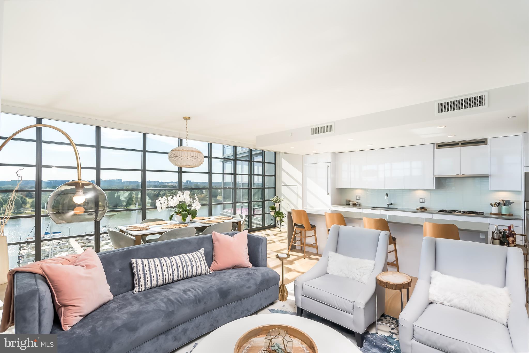 Amazing opportunity to own one of the most desirable panoramic water views in DC overlooking the thriving District Wharf and Marina from 7th stories up. Entertain across almost 2,200 sf inside and out in style as you step onto your living room or master bedroom balcony with a view for miles down the Potomac River and across to the shore-lined Cherry trees unlike any other condo view in DC. Natural light abounds with floor-to-ceiling windows throughout this 3BR 2.5BA "09" tier unit at VIO. Modern luxury at every turn: white oak hardwoods, marble baths, quartz counters & Porcelanosa cabinetry. Private elevator lobby with elevator opening directly to your unit. 2 garage parking spaces + conditioned Storage Unit included. Pool, fitness & 24-hr Concierge on-site and low condo fee.  By Appointment, see Virtual Tour Link.