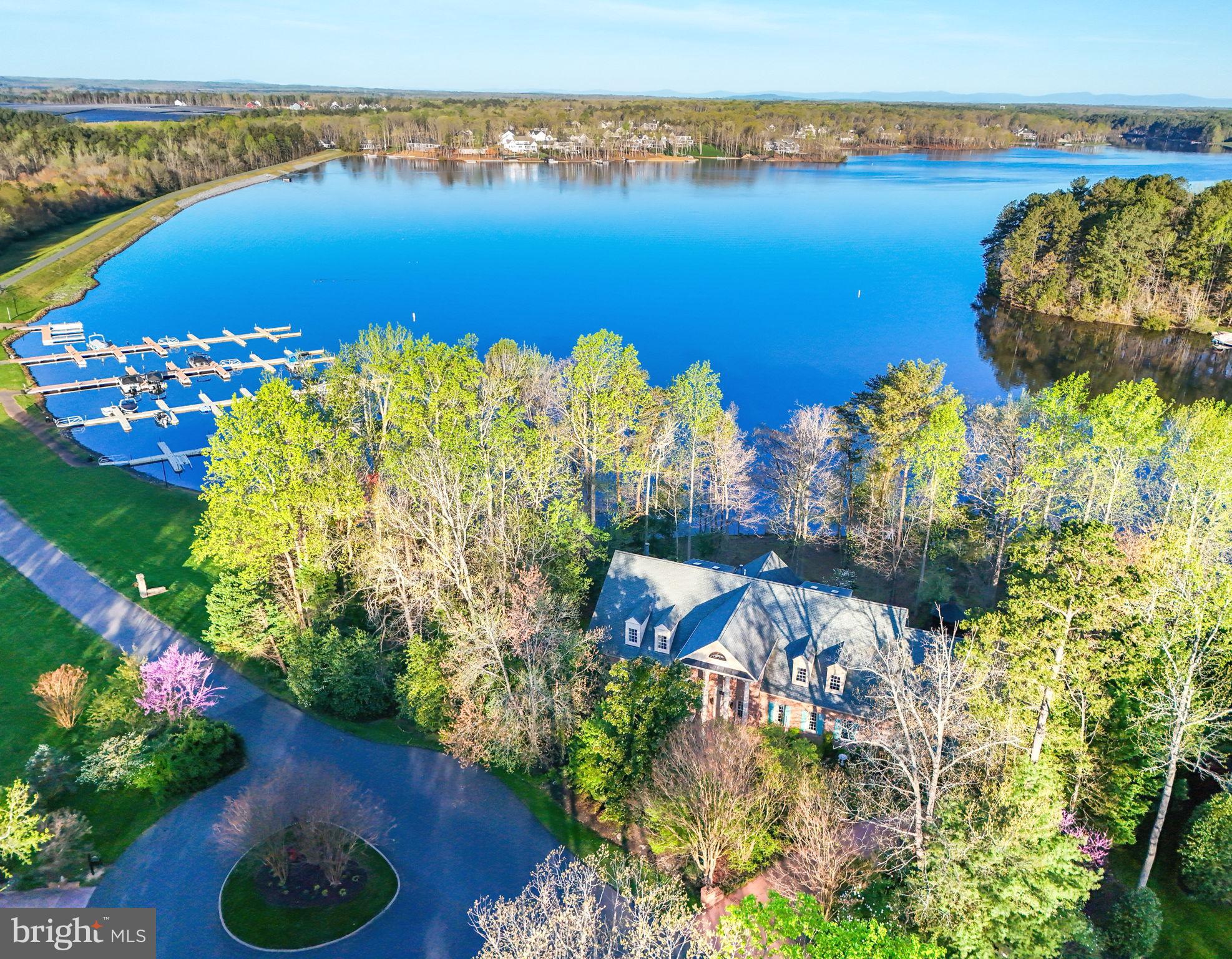 Spectacular Waterfront Dream Home inside the gated resort community of Fawn Lake!  Nestled on a picturesque 1.09-acre lot with 300 feet of pristine shoreline, this truly exceptional lakefront estate offers the ultimate in tranquil, resort-style living. Commanding panoramic views of the serene Fawn Lake and its stunning sunsets, the sprawling 6,992 square foot home is a masterpiece of design and craftsmanship.

As you step through the two-level foyer, you're immediately captivated by the towering two-story family room, where floor-to-ceiling windows frame the breathtaking lakefront vistas. Just off the main living area, a convenient coffee bar leads into a grand, well-appointed mudroom - the perfect space for storing outdoor gear and essentials.

The home's gourmet kitchen is a culinary enthusiast's dream, featuring custom cabinetry and a magnificent double island. On the main level, you'll also find a luxurious master suite that opens to a private deck overlooking the tranquil waters, as well as an additional spacious secondary bedroom.

Upstairs, the home offers three more generously-sized bedrooms, along with a versatile den/office space. The fully finished walkout basement provides even more living and entertainment space, seamlessly connecting to the lush, landscaped backyard oasis. This backyard paradise boasts a serene koi pond, meandering stream, and an outdoor gazebo equipped with electricity and water - an idyllic setting for summer gatherings.

Complementing the exceptional indoor living areas is a sprawling 3-car garage, with a dedicated laundry room conveniently located just off the garage entrance. This remarkable property truly offers the ultimate in lakefront luxury, blending elegant finishes with unparalleled amenities and breathtaking views.

The beautiful gated Fawn Lake Community offers an array of amazing amenities, including a boating recreational lake, beach, golf course, tennis courts, soccer and ball fields, dog park, volleyball courts, walking trails, Club House, marina, fitness center, restaurants, Country Club, playgrounds, and more. Nestled in the countryside near protected park lands, the community is only a few miles away from farmers markets, wineries, and award-winning breweries.