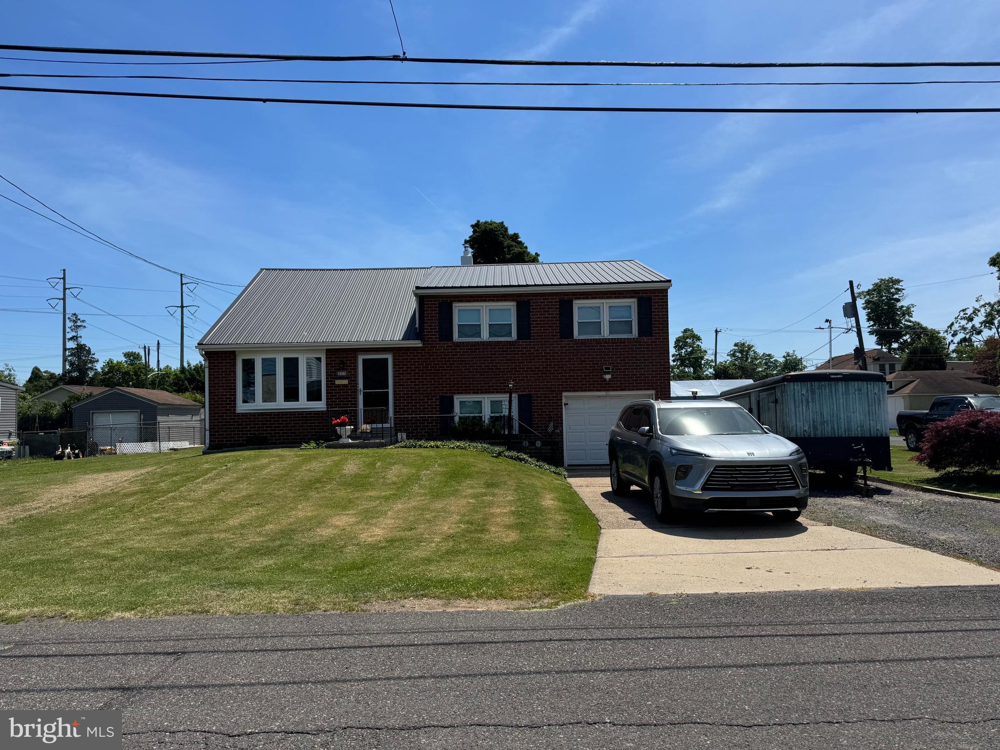 Welcome to this large, well-maintained home with 4 bedrooms and 2.5 bathrooms that's situated on what was originally 4 lots! Possible In-law Suite that would add a 5th bedroom to the total. Beautiful Sunroom. Attached garage with inside access & a workbench. All windows (vinyl clad, double hung, easy clean tilt) replaced 10 years ago plus a new front Pella bow window 2 years ago! INTERIOR: Luxury wide plank flooring over original hardwood installed in 2025! Livingroom has an Electric Fireplace & crown molding. Kitchen remodeled within 3 years with granite countertops, solid wood oak cabinetry, crown molding, Stainless Steel Appliances include a built-in SS Microwave & Dishwasher, SS Range all 5 years old & a New Double door SS Refrigerator in 2026! Granite Breakfast Bar divides the Open Kitchen & Dining Room. Tranquil Sunroom with SGD & lots of windows also has a door to the rear yard! LED lighting throughout! The lower-level Family room could easily be transformed into an In-Law Suite because it has entry level access off the Laundry Room (with washer, dryer, utility sink & storage cabinets) and the Half Bathroom could easily become a Full Bathroom by installing a shower where the linen closet is (pipes for a shower are already in the wall) and the kitchen is just a few steps away that could become a "shared kitchen", just add a door at the bottom of the steps for privacy! There's a big basement with newly painted concrete floor, a bar, a pool table (included), a Pantry cabinet and lots of storage! There's a French Drain and there has never been a drop of water enter this basement from the outside! Upstairs there are 3 Bedrooms and a Full remodeled Bathroom with a walk-in shower that's 5 years old and the stainless-steel grab bars have been reinforced. Attic access is in the closet of the 1st bedroom. Go up another couple of steps is the Main Bedroom with En Suite Bathroom with a glass enclosed shower stall, a walk-in closet, its own Mini-Split HVAC and access to another attic space for more storage. Ceiling fans in every room. Colonial panel doors. Access the Garage from the laundry area. The Garage has a steel interior door, workbench, metal shelving (some can stay) and an overhead door leading to the driveway.
EXTERIOR: 2 Outbuildings= 20x 20 workshop/shed with electric & flood lights. Huge, covered Deck and open Patio.  Plenty of space to park an RV & Boat trailer or lots of cars. All new wiring with 200 amp service! New exterior electric entry cable. Corner Lot! Dedicated, fenced Garden area + hardscape raised bed garden planters. 20 Year old Gorgeous dwarf Japanese Maple. Firepit. Fenced yard with double gates plus 2 additional gates. Sensor lighting. Lots of yard space front, back & sides! New Metal Roof in 2025, Freshly Painted Exterior, Oil heat & Central Air plus Mini-Splits! Reinsulated - R30. Central air & oil heater serviced every year. Fire hydrant on corner of the lot. Great property for a Landscaper or folks who have lots of recreational toys:) Everything has been remodeled/maintained/replaced and lovingly cared for! Great location just minutes to the PA/NJ Turnpike, I-95 and the Burlington-Bristol Bridge, next to Rt 13 & 413, quick access to the Croydon Train Station, Shopping, BCCC Bristol Campus, MORE! This is a BIG HOME ON A BIG LOT WITH MANY POSSIBILITIES!