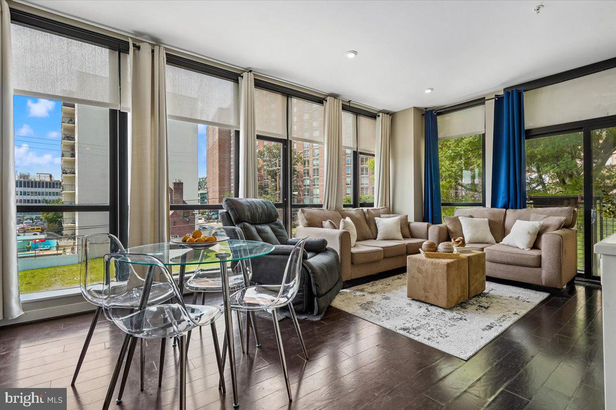 Welcome to your stunning 804 sq.ft. condo in the heart of downtown Silver Spring! This elegant space features a bright living room with impressive, two sides of floor-to-ceiling windows and a charming Juliette balcony that overlooks green space and a tranquil fountain. Just two blocks from Mom's Organic Market and directly across from the Montgomery County Aquatic and Recreation Center, you’ll enjoy a vibrant lifestyle with convenient access to local amenities. Commuters will appreciate being close to the Silver Spring Metro station and the upcoming Purple Line. The unit boasts modern finishes, including quartz countertops, stainless steel appliances, and wood flooring throughout. You'll also find a full-size in-unit washer and dryer and an extra storage unit for all your needs. Enjoy breathtaking sunsets and building amenities such as a fitness room, lobby/club room with fireplace, free wi-fi in the common areas, sky lounge/party room, and roof deck with views to downtown Bethesda and the Mormon Temple —this condo truly has it all!