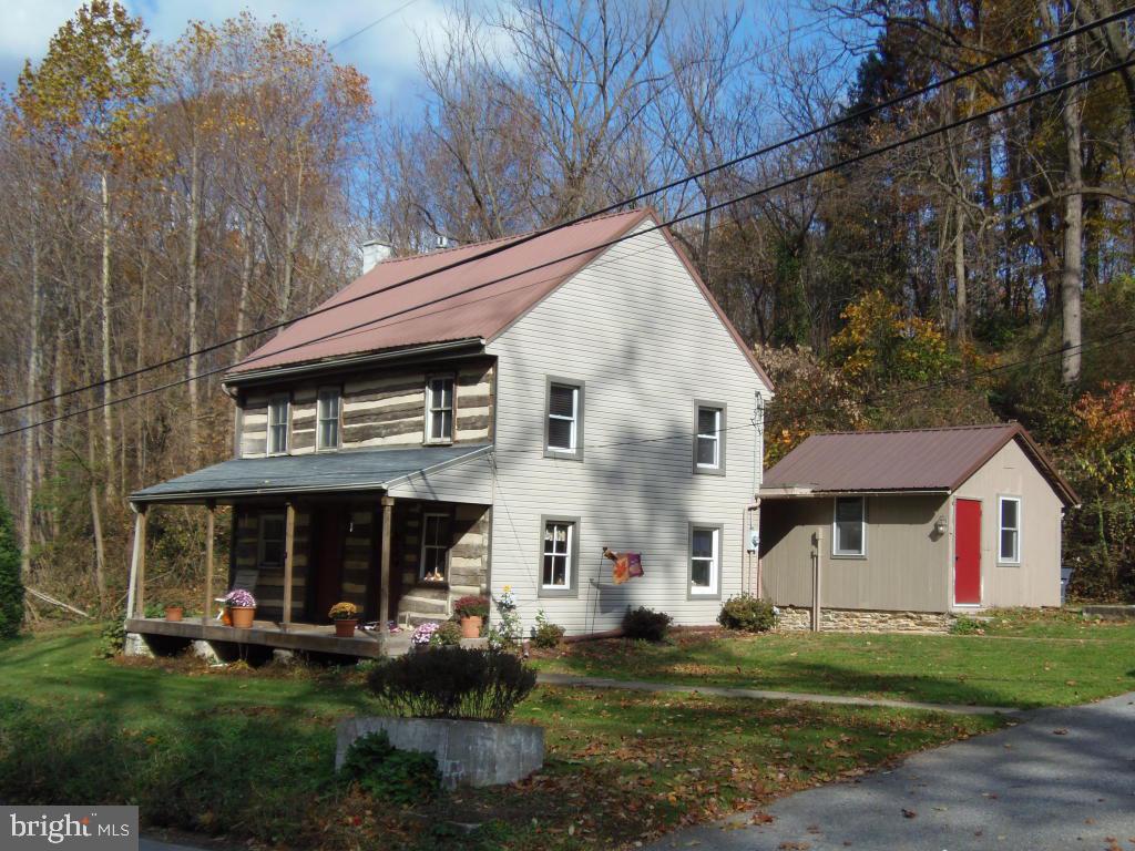 CHARMING HISTORICAL LOG HOME WITH CHARACTER WITH EXPOSED LOG WALLS AND WOOD BEAMS. UPDATES THROUGHOUT INCLUDING UPDATED KITCHEN AND LARGE MAIN BATHROOM WITH WHIRLPOOL TUB. HARDWOOD FLOORS AND PROPANE STOVE IN LIVING ROOM. NICE PATIO, FULL FRONT PORCH AND 2-CAR DETACHED GARAGE.MATURE LANDSCAPING AND CONVENIENT LOCATION.