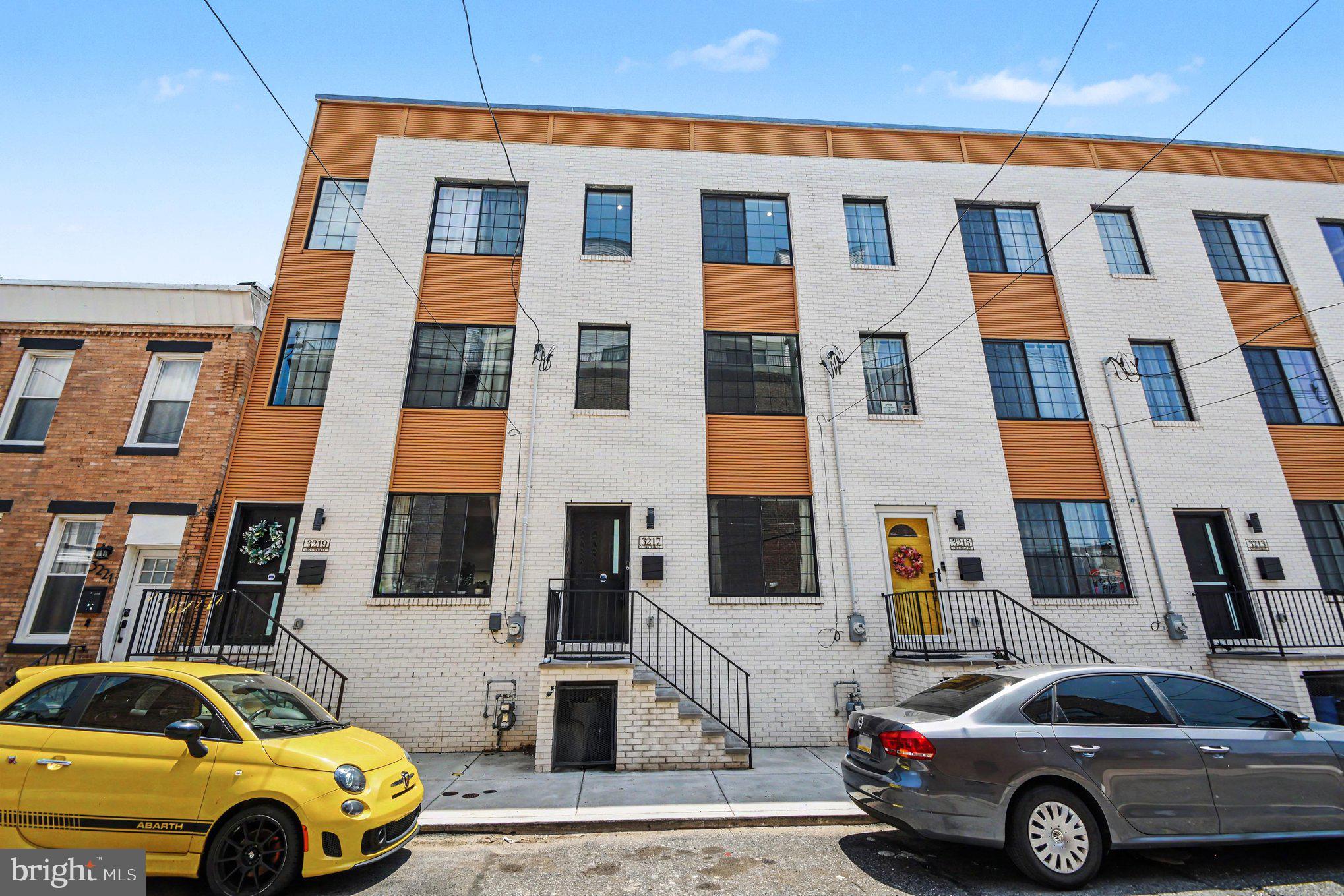 Welcome to Luxury Living reimagined at the spacious 3217 Chatham Street,  a 4 Bedroom 3 Bathroom home in the heart of Port Richmond with over 2,700-sq-ft of thoughtfully crafted usable space. The space delivers an unmatched blend of design creativity and superior finishes. This 3.5-year-old construction stands in a league of its own. Best of all, it features 6.5 years remaining on a transferable real estate tax abatement. On the main level you’ll be greeted by a generous, open-concept floor plan flowing effortlessly from a large living room into a dedicated dining area accented by a sleek electric fireplace. As you enter into the chef’s kitchen, a true gathering hub, you’ll be amazed by an expansive island, premium quartz countertops, and a matching full-height quartz backsplash. The kitchen seamlessly flows into the 30 foot enclosed outdoor space for entertaining ease.  The outdoor oasis features a patio, grassy space as well as a pergola. As if the main floor and outdoor space wasn’t enough you’ll find a massive, versatile lower level boasting multi-purpose rooms perfect for a home office, gym, or movie area, and a pristine full bathroom. On the second floor you’ll find sun-drenched bedrooms situated at opposite ends of the hallway for maximum privacy, sharing a beautifully styled ceramic-tiled full bathroom and a convenient laundry room.
Make your way to the primary bedroom third floor, a true sanctuary occupying the entire level. The floor features a private wet bar with custom cabinetry and a wine fridge for entertaining ease on the rooftop deck, dual "his and hers" walk-in closets, and a large primary bathroom with double-sink vanity, a magnificent, ceramic-tiled oasis complete with a rainfall shower and a deep soaking tub. The finished touch to this amazing property is a fiberglass roof deck offering panoramic, breathtaking views of the Philadelphia skyline, day and night.
Enjoy a built-in multi-zone speaker package (Main Level, Owner's Suite, Spa Room, and Rooftop Deck), Comprehensive built-in security alarm system and Integrated security cameras and video doorbell. Book your tour today!