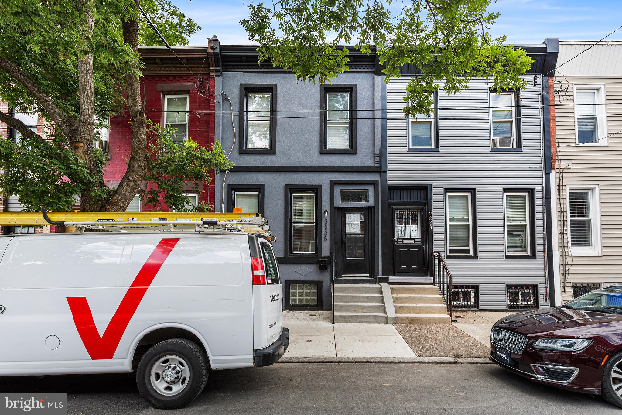 Beautifully Updated South Philly Home with Recent Improvements!  2235 Tasker Street offers an ideal blend of comfort and modern convenience. Enter into a bright, open living and dining area featuring fresh paint throughout, brand new flooring, a new stair hand railing, and modern recessed lighting. The kitchen has been upgraded with new cabinets, granite countertops, and all-new appliances including the stove, microwave, dishwasher, and refrigerator. A rare first-floor powder room adds extra convenience for guests. From the kitchen, step straight out the rear door into your private backyard. Complete with a brand new privacy fence and new concrete floor, this space is ready for outdoor cooking, summer BBQs, and entertaining guests. Upstairs, the home boasts fresh paint, new flooring across the bedrooms, individual brand new wall heating and cooling units, and a beautifully remodeled full hallway bath. Downstairs, the freshly painted, finished basement features durable tile flooring and laundry hookups. This flexible space is perfect for a home office, personal gym, or extra storage. Complete with brand new front and rear stucco and many new windows, this beautiful home is ready for its next owner. Perfectly positioned in a rapidly growing South Philadelphia neighborhood, this move-in ready gem places you minutes from popular local spots like Dock Street Brewery, American Sardine Bar, and great nearby parks. Commuting is a breeze with easy access to Broad Street, public transit, and major roadways, making for a quick trip to Center City, the Navy Yard, Drexel University, or UPenn. Don't miss this incredible opportunity—schedule your private tour today!