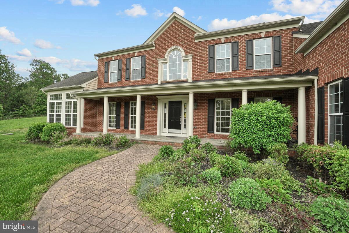 JUST REDUCED!! Owners relocating - their loss is your gain. Your dream home awaits! This home boosts a commuter friendly location to Washington DC or Baltimore, MD in one of Howard County's most highly sought after school districts.  Brick front, scenic setting, and an inviting slate covered front porch await! Grand two-story foyer embellished with an intricate dual staircase and a stone accent wall, imposing formal living and dining room, solarium, large Butler's pantry, and a welcoming family room adorned with a stone profile wood burning fireplace encompass the main floor. Top of the line granite countertops in the kitchen and all bathrooms, hardwood floors on the main and upper level! Many upgrades too numerous to list.  The  kitchen highlights include custom cabinetry, accent center- Island, prep sink, double gas stove, breakfast room, and an adjoining sunroom. Spacious owner's suite boasts a tray ceiling, sitting room, architectural columns, sitting room, and two walk-in closets. Five vastly sized bedrooms with walk-in closets, dual entry bath, and ensuite bathrooms conclude the upper level. The lower level boasts a beautiful stone wet bar, additional BONUS room, full bath, and theatre/music room. Three-car garage with side access to the home. A expansive deck overlooks an amazing view of the property situated on 3 scenic acres.  OPEN HOUSE - September 22nd from 1-3pm