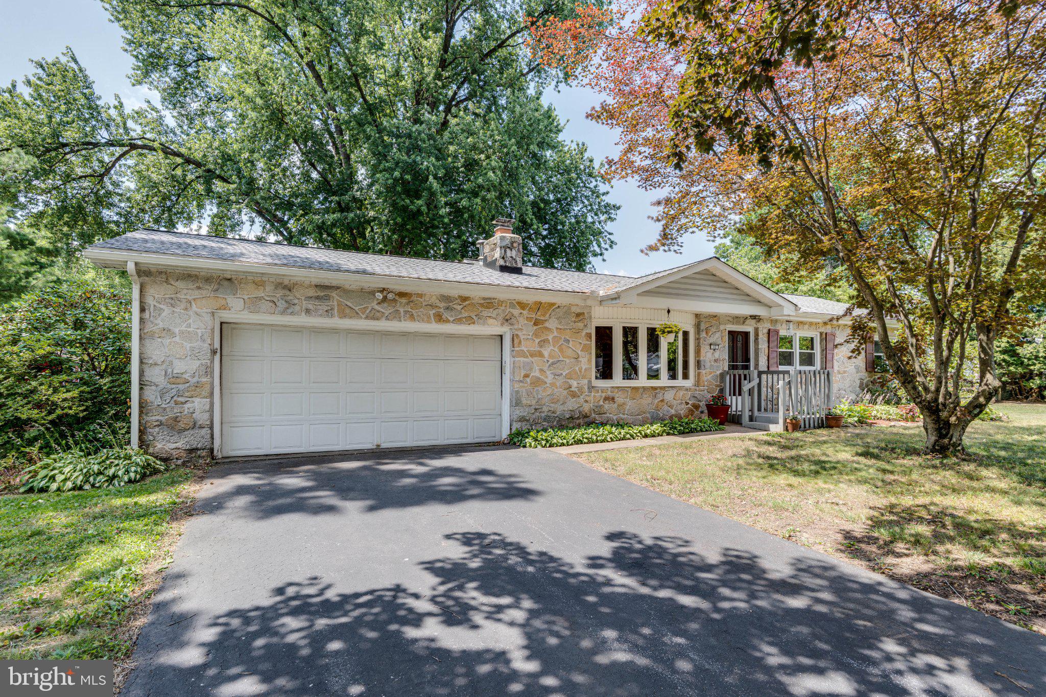 Welcome to 12 Heather Lane, where timeless stone construction meets thoughtful updates. This well-maintained ranch home offers the convenience of one-floor living while providing the space and features today's buyers appreciate. Inside, you'll find three bedrooms, including a spacious primary suite with a beautifully renovated private bath featuring a walk-in shower. The updated hall bath offers dual vanities and a tub/shower combination. Hardwood flooring extends through much of the home, while the living room serves as a warm and inviting gathering space with a stone-faced wood-burning fireplace and a large bay window that fills the room with natural light. The updated kitchen provides generous cabinet storage and opens to a sizable four-season room highlighted by charming atrium windows and French doors leading to the rear deck, creating an ideal space to enjoy the changing seasons or expand your everyday living area. The full unfinished basement offers excellent potential for future finishing or storage and includes a French drain system, dual sump pumps, and Bilco doors for exterior access. Additional improvements and features include: New roof (2025), reverse osmosis drinking water system, HVAC system approximately 10 years old with servicing completed within the past year, active radon mitigation system, well water testing completed within the last year, two-car attached garage with interior access and rear service door. Situated on nearly one-half acre, the level lot is enhanced by mature trees and established landscaping, offering both beauty and functionality. A hydraulic wheelchair lift is currently installed and may be included with the sale. If you're searching for the character of a classic stone ranch combined with meaningful updates and room to make it your own, 12 Heather Lane is ready to welcome you home. Notice to buyer: Some images have been virtually staged.