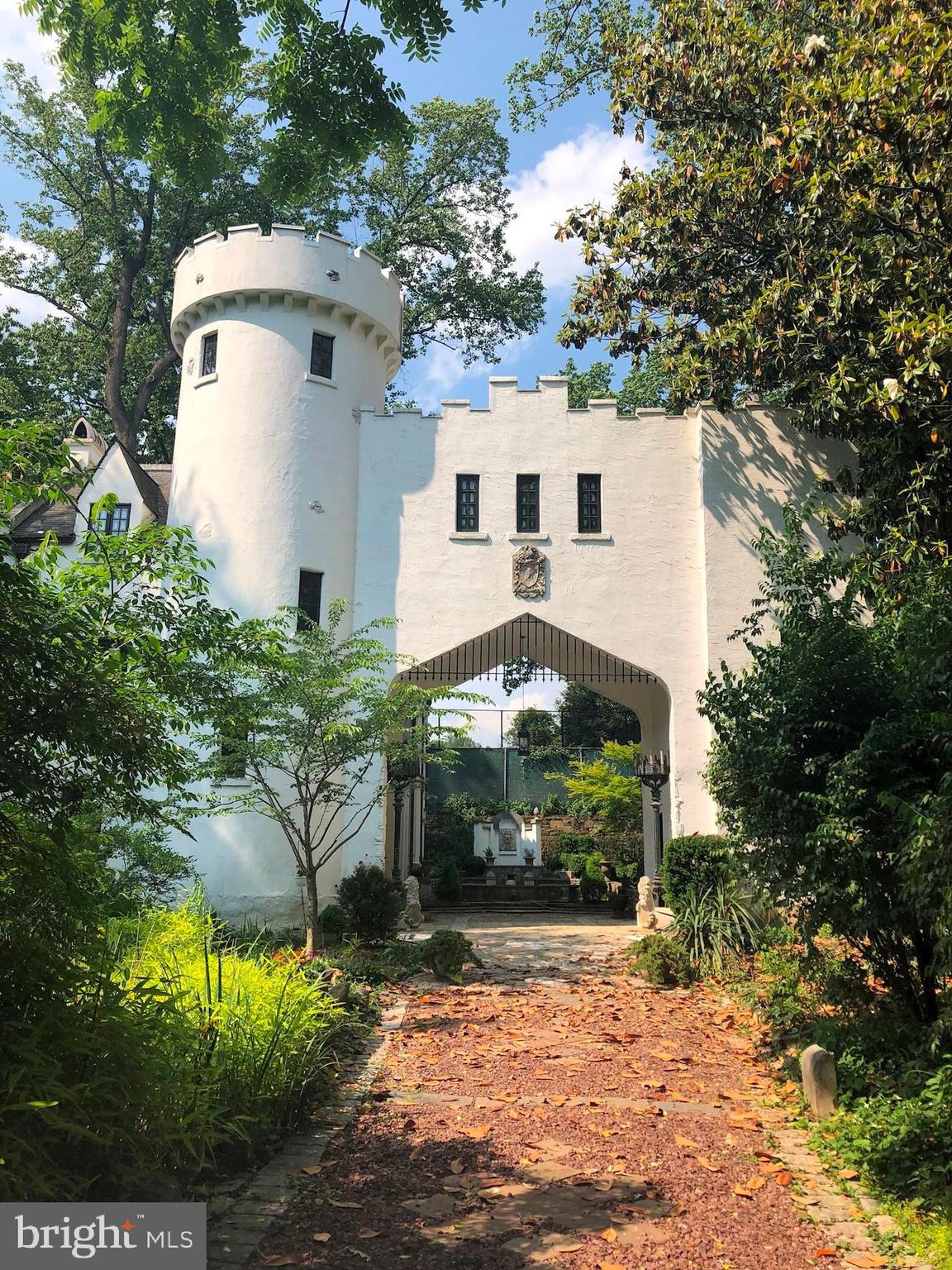 Tucked away within the welcoming and bustling Chevy Chase neighborhood resides 3207 Woodbine Street, a true, once-in-a-lifetime residence. This extraordinary 1927 Scottish Tudor Castle Gatehouse offers 4 Bedrooms, 3 Full Baths and 2 Half Baths across 4 artistically crafted levels and 4,600 square feet, with interior design notes such as hardwood and tile flooring, beamed ceilings, arched entryways, crown molding and built-ins throughout. 

The enchanting and elongated walkway, lined with abundant greenery, guides residents and guests alike to the regal Castle Gatehouse, paved with stone walkways leading to the Terrace, Portico and Courtyard. With intricately designed flagstone, abundant and mature landscaping, elegant fountains and a seating area, the entry Courtyard will surely capture any resident’s attention and heart, offering a vacation-like experience within the comfort of one’s own home. The entry Foyer, lined with a French door and windows, flanks the spiral staircase and Gallery. The Gallery offers sizable built-ins and ample wall space; an ideal canvas to display one’s passion for design or cherished memories. The Main Level Bedroom embodies the ideal guest room, with a stylish and private Full Bath and sizable closet a mere few feet away. The Main Level hall, flooded with natural light and showcasing detailed crown molding, flanks the Utility Room and Library. Surrounded by stately built-in bookshelves, the Library presents an intimate setting to showcase prized collections and dive into the world of one’s thoughts and imagination. 

Ascending the regal spiral staircase to the Upper Level, the spacious formal Living Room awaits, complete with a grandeur fireplace and French doors with Balcony and Terrace access. The Balcony, complete with a ceiling fan and wood-beamed ceilings, overlooks the entry Courtyard and offers an idyllic and intimate al fresco dining experience; enjoy your morning coffee and the beautiful spring weather in this pocket of serenity. The Eat-In, Gourmet Kitchen presents marble countertops, a marble island with stained-glass detailing, and intricate and bountiful cabinetry; at-home chefs and homemakers will come alive in this craftspace filled with warmth and life. Within the Gatehouse of this Upper Level, an Office Space is tucked away, offering built-ins and enviable privacy. An elegant Dining Room and Powder Room complete this level’s offerings. 

Ascending to the Third Level, an attractive hallway with built-ins leads residents to the tasteful Primary Bedroom, showcasing a spa-like ensuite Full Bath, complete with a stall shower and dual vanity; decompress from the week in this calming oasis.  The Second Bedroom or optional Family Room instantly draws the eye with its abundant natural light and sizable space. The Third Bedroom boasts a Full Bath as well, in addition to a ceiling fan and colorful window frames. This level is complete with a Powder/Laundry Room. 

At the top of the winding spiral staircase, the Fourth Level presents a Loft and breathtaking Rooftop Deck, with stunning treetop and pond views; looking out from this spectacular space, residents will feel like royalty! The side flagstone Terrace offers a larger al fresco dining setting to host dinner parties and celebrate milestones at ease.

Within close proximity to the popular Beach Drive and Rock Creek trail, local playgrounds, parks, dining and shopping, 3207 Woodbine Street is surrounded by residential community whilst simultaneously offering idyllic privacy in a grand and blissful residence. Stop by and discover your fairytale ending at 3207 Woodbine Street today!