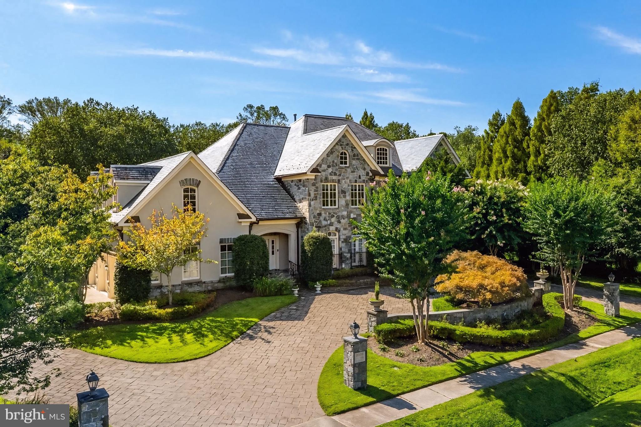 Welcome to an extraordinary 0.83-acre estate, an entertainer’s dream offering lush landscaping, an expansive patio, a sleek negative edge pool, outdoor fireplace, and a fully equipped outdoor kitchen perfect for lounging and dining al fresco. A circular driveway leads you to stately double doors and into a breathtaking two-story foyer, where an elegant curved staircase and shimmering chandeliers introduce the home’s sophisticated aesthetic. Granite and marble accents, custom millwork, and soaring ceilings elevate each space, while five fireplaces add warmth and ambiance throughout the nearly 8,900 square foot interior. The formal living and dining rooms exude timeless elegance, each graced with French doors that open to Juliet balconies overlooking the grounds. The gourmet kitchen is the heart of the home, a showcase of custom cabinetry, a generous center island, and premium appliances including a warming drawer and wine refrigerator. It seamlessly unfolds into the sunlit breakfast room and the inviting family room, where coffered ceilings, built-in cabinetry, and floor-to-ceiling windows create a seamless connection to the outdoors. Thoughtful details continue on the main level with a sunroom, butler’s pantry, walk-in pantry, laundry room, and two well placed powder rooms. The the upper level is a retreat to the luxurious owner’s suite, an intimate haven offering a private fireplace, dual walk-in closets, and a spa inspired bath. Three additional bedrooms, each generously sized are paired with beautifully designed baths. A striking media room with its own full bath adds a touch of cinematic indulgence. The lower level has a spacious recreation lounge with wet bar invites gatherings of every size. A dedicated fitness studio, massage room, and a full bath with a steam shower create a personal wellness retreat. A guest bedroom with full bath, a wine cellar, and abundant storage. This Fox Haven estate is more than a home, it is a lifestyle of elegance, comfort, and unforgettable moments, offering resort style living just minutes to world class shopping and dining.