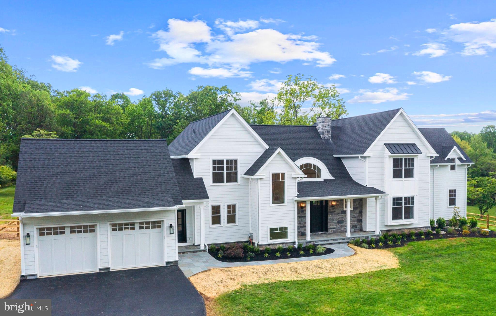 Welcome to 3718 Gradyville Road, a truly exceptional new construction estate by GKV Custom Homes, now complete and move-in ready. Situated on a sprawling 2.5-acre lot with no HOA, low property taxes, and the rare combination of privacy, space, and convenience, this residence offers an elevated lifestyle in the heart of Newtown Square.
This 5-bedroom, 4.5-bathroom home features over 5,800 square feet of thoughtfully crafted living space. From the moment you step inside, you’ll be welcomed by soaring ceilings, oversized windows, and custom architectural details that blend elegance with functionality. The grand two-story great room is centered around a sleek vertical fireplace and is framed by a dramatic second-floor wraparound hallway. Just beyond, the space flows effortlessly onto a covered back porch—perfect for entertaining, dining outdoors, or relaxing in a peaceful setting.
At the heart of the home, the gourmet kitchen boasts designer cabinetry, high-end finishes, a spacious center island, and premium appliances. Oversized windows flood the space with natural light while offering tranquil views of the private backyard.
The layout also includes a formal dining room, private office, and a generous bonus/media room. A highlight of the main level is the first-floor secondary master suite, ideal for guests, multi-generational living, or a private home retreat.
Upstairs, discover generously sized bedrooms and spa-inspired bathrooms, including a luxurious primary suite designed with comfort and serenity in mind. Additional features include a finished partial basement, an attached two-car garage, and ample storage throughout.
Outdoors, the flat and expansive 2.5-acre lot offers endless possibilities—whether you envision a pool, outdoor kitchen, or custom landscaping. Surrounded by mature trees and lush greenery, the setting provides privacy and a sense of seclusion, all while being just minutes from top-rated schools, excellent dining, and convenient shopping.
Freshly completed and more than move-in ready, this home is a rare blend of timeless design, exceptional craftsmanship, and modern luxury—set in one of Delaware County’s most desirable locations.
Schedule your private tour today and experience the quality, space, and lifestyle this one-of-a-kind home has to offer.