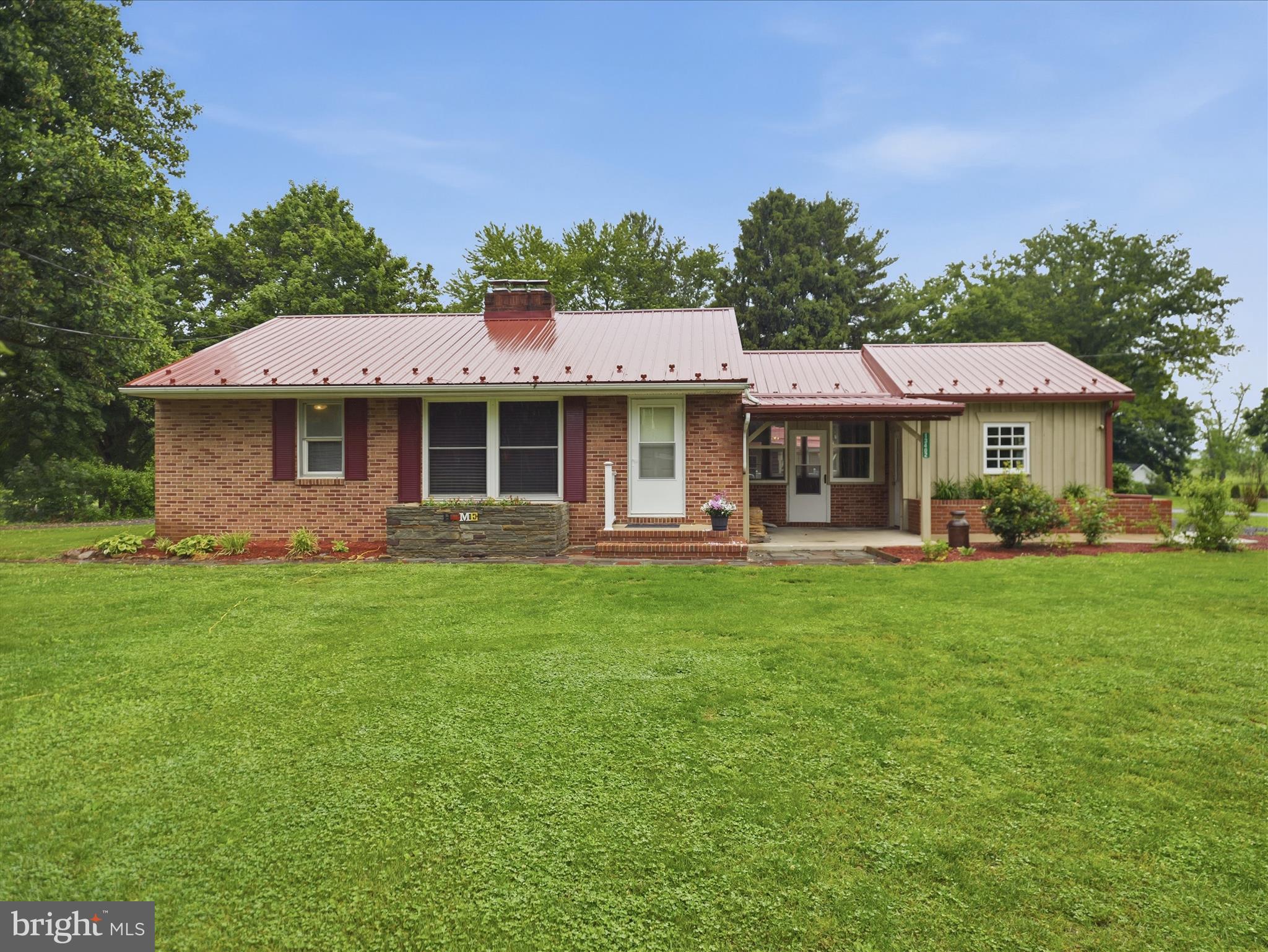 The perfect place to call home! There is so much to love about this spacious all-brick rancher situated on a full acre in beautiful Smithsburg, MD. Freshly painted with brand new carpet throughout, this home is truly move-in ready. Features include two wood-burning fireplaces, a kitchen with stainless steel appliances, a bright sunroom, full basement, and partially fenced backyard — just to name a few. The attached garage offers an automatic door for convenient access to the wraparound driveway. A detached 25x25 garage with electric, multiple sheds and outbuildings, plus a separate secondary driveway, provides endless possibilities for hobbies, storage, a home business, or extra workspace. Enjoy peaceful surroundings with plenty of room to spread out while still being close to everything you need. There is nothing left to do but move right in. Don’t miss this incredible opportunity. Schedule your showing today!